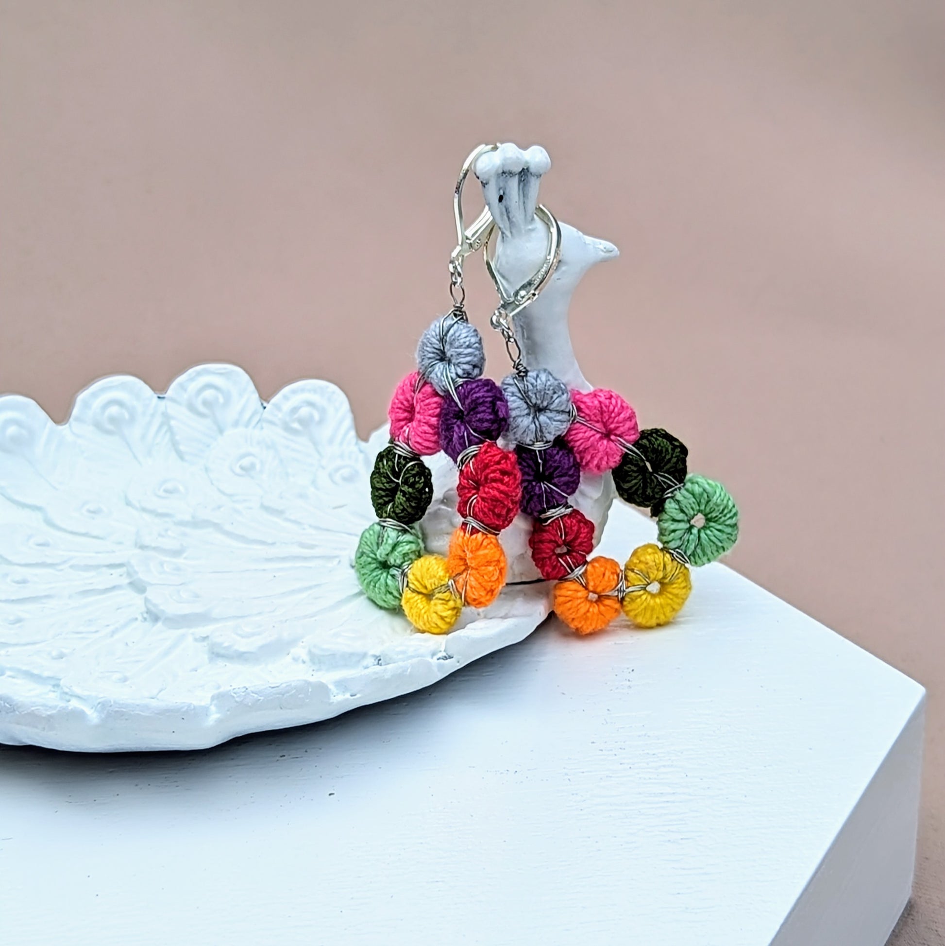 Rainbow teardrop crochet earrings on hand, Komali Hope Springs one-of-a-kind sustainable jewellery.