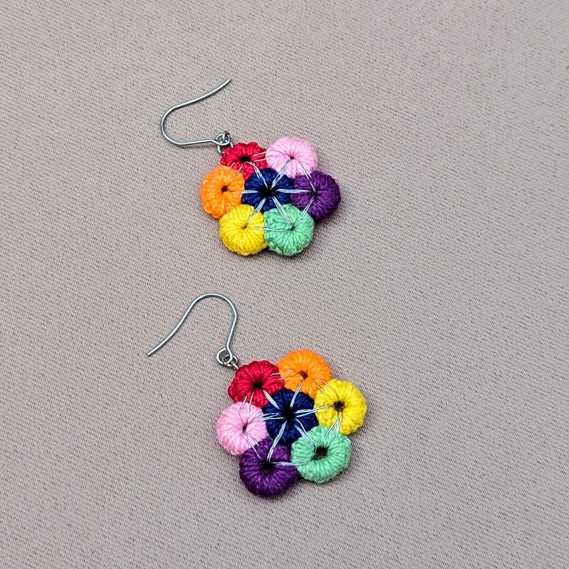 Close-up Komali Chakra earrings showing multicolour crochet rings and minimalist bead-free design.