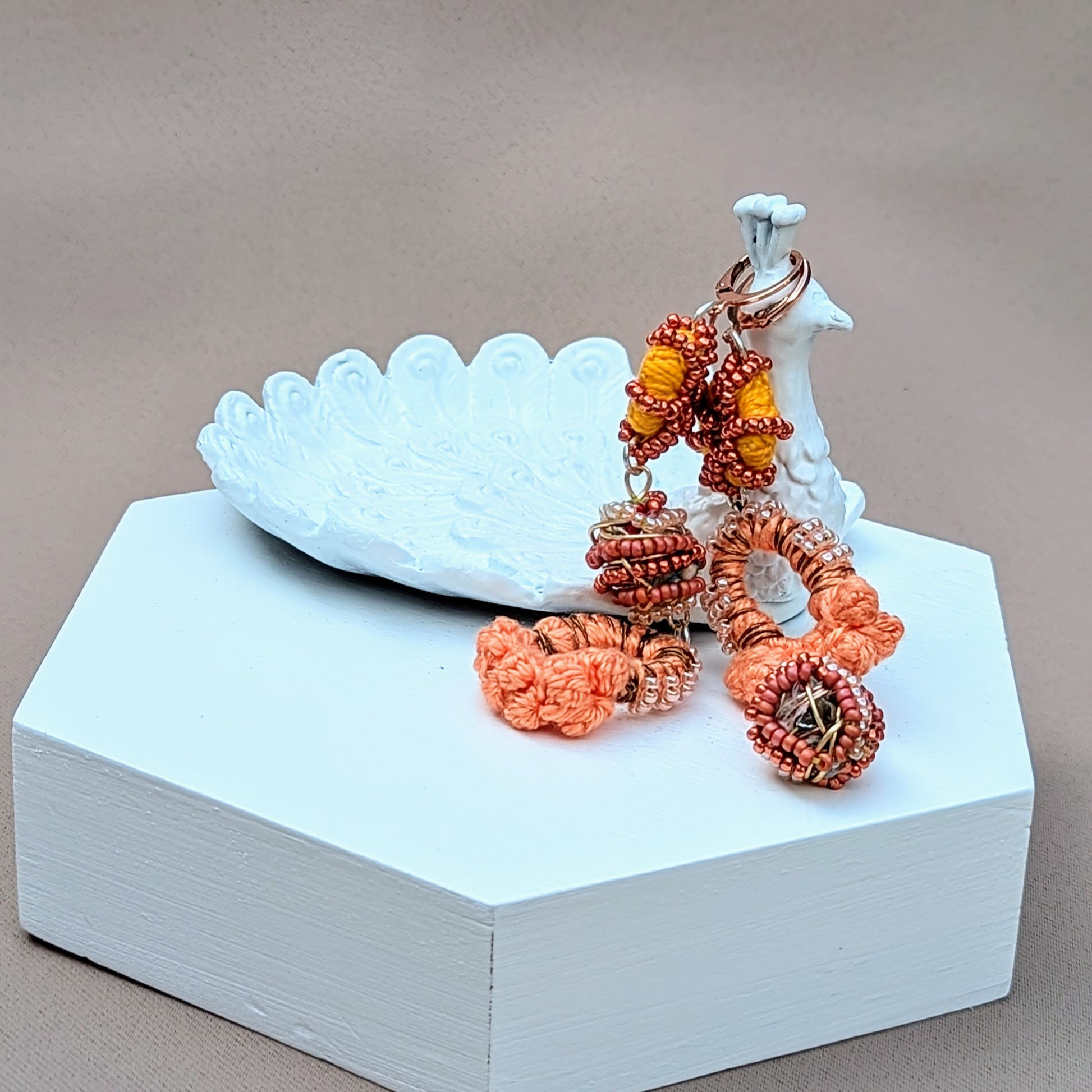 Handcrafted peach beaded jhumka-style earrings with soft movement.