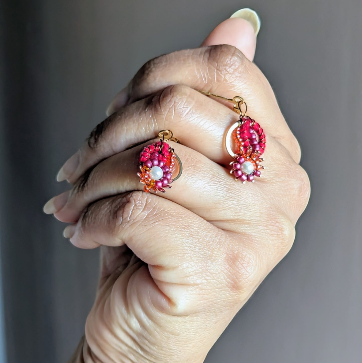 Hypoallergenic red crochet and bead earrings with gold-plated floral details by Mayaani Jewellery.