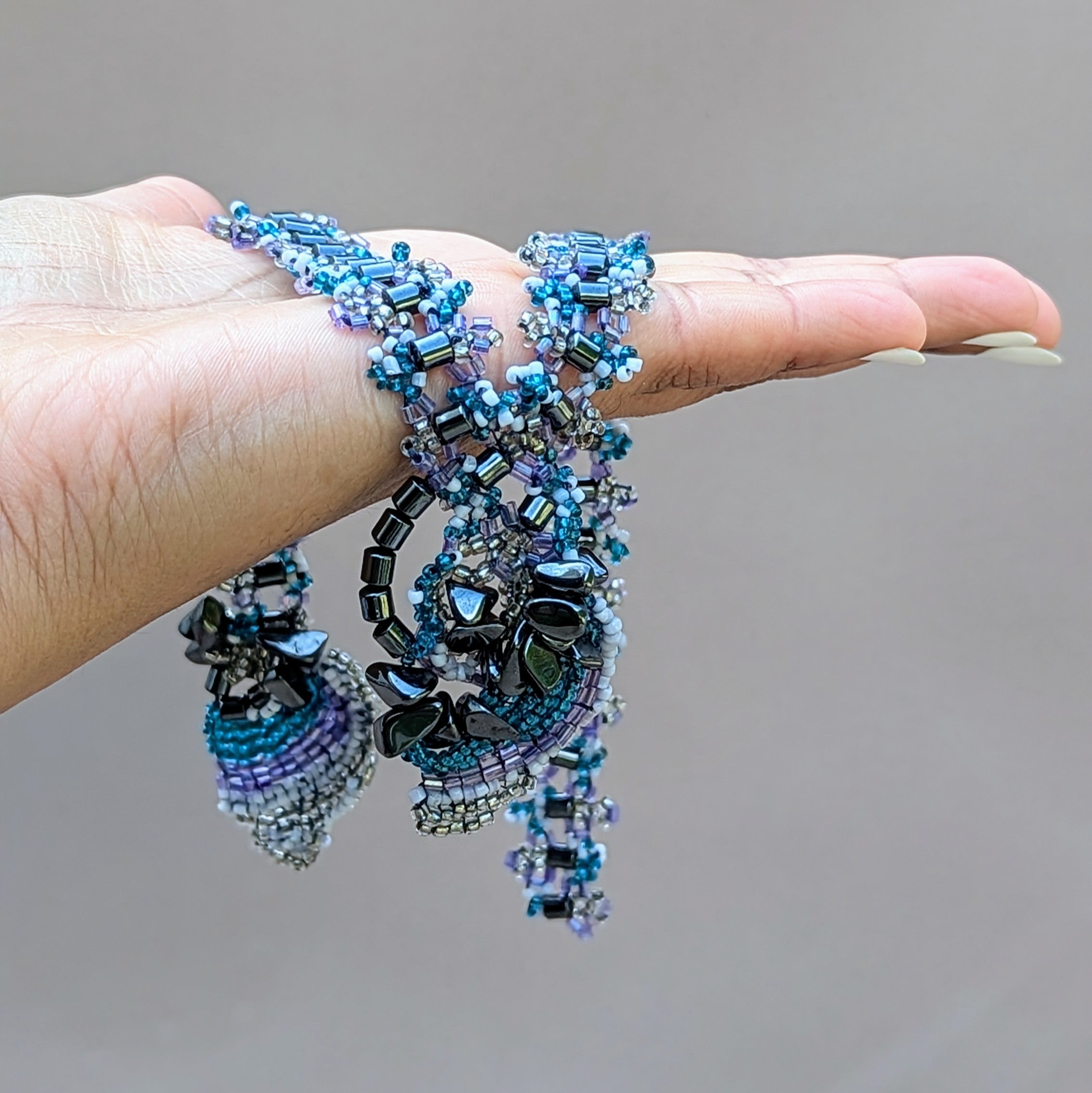 A one of a kind lilac blue vintage upcycled hematite bead necklace exclusive to sustainable UK brand Mayaani Jewellery handcrafted by UK Indian designer and artisan Megha.