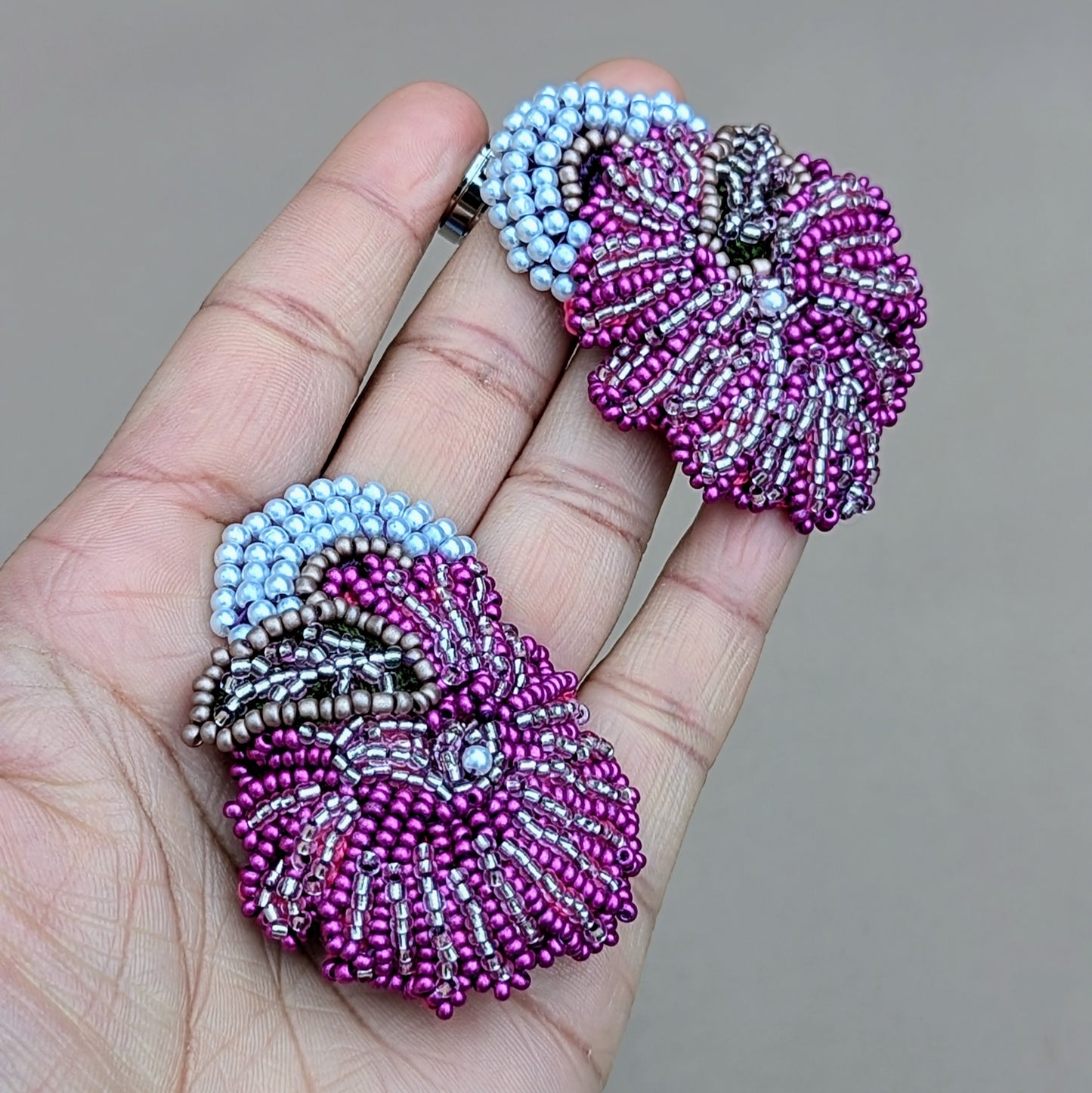 Handheld view of Lila beaded earrings highlighting intricate bead embroidery.
