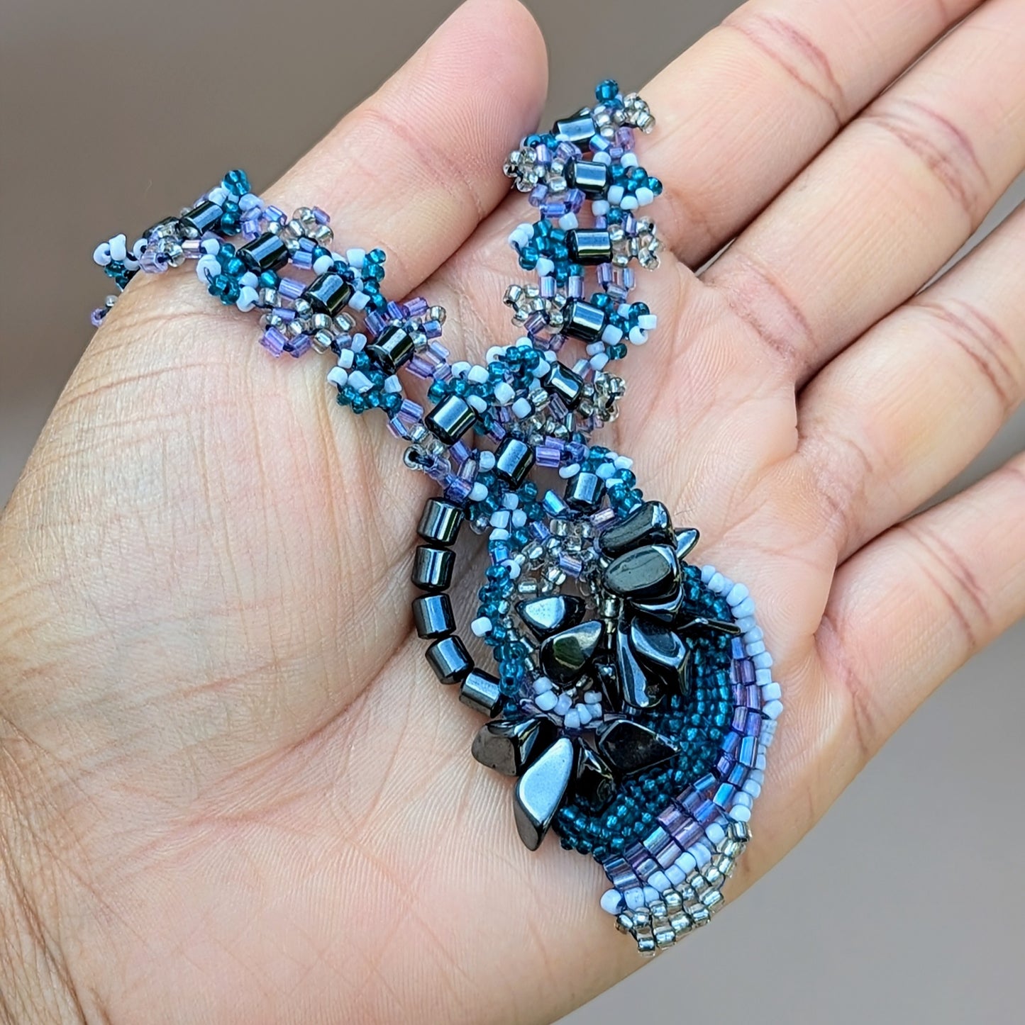 Detail of upcycled hematite pendant and beaded texture from Mayaani Jewellery’s vintage-inspired collection.