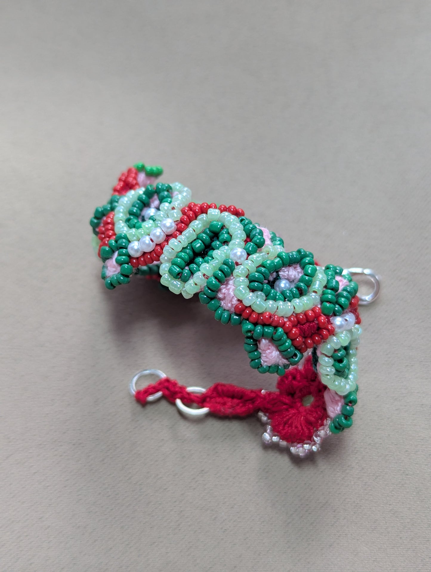Handmade Malika beaded bracelet in green, red and silver with vintage pearls and crochet details.