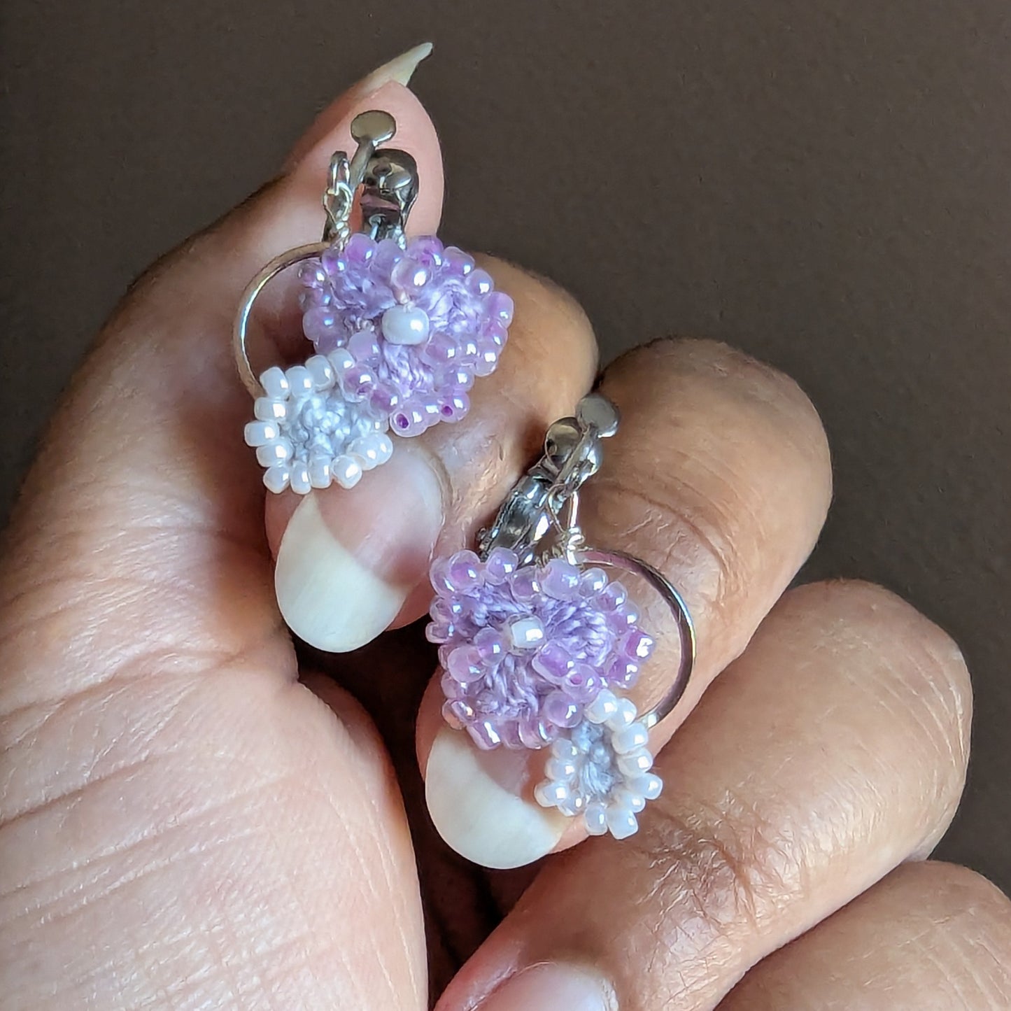 Malti clip-on earrings close up - lilac Czech and Japanese glass seed beads with pearl centre and stainless steel hoop frames.