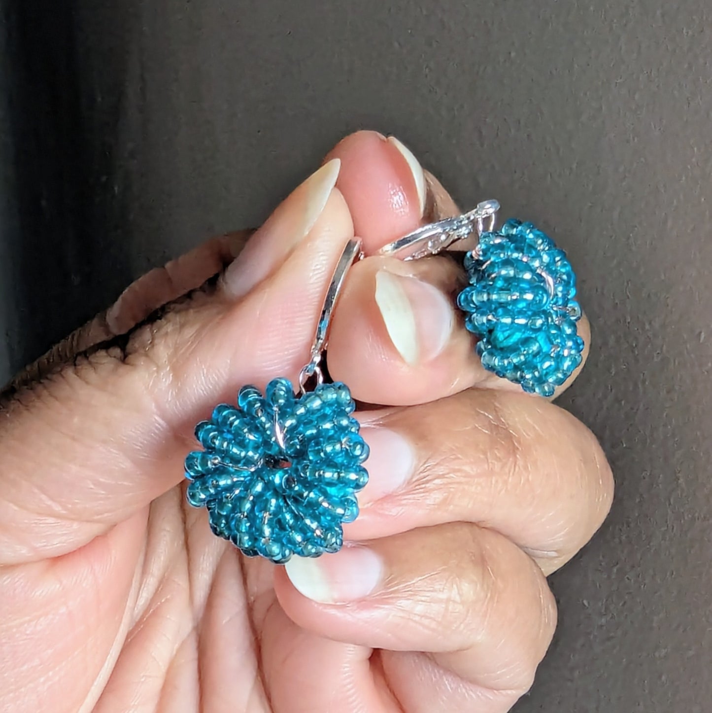 Pair of Masi Blue handcrafted earrings featuring luminous blue glass seed beads woven with Egyptian cotton thread.