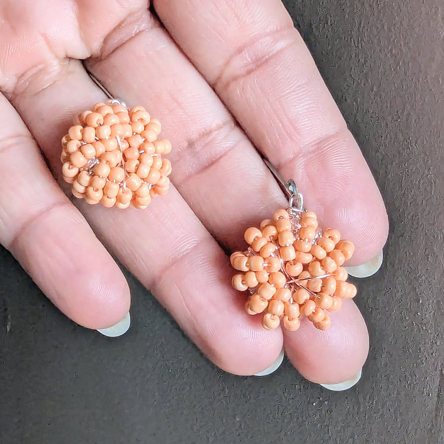 One-of-a-kind peach glass bead earrings radiating soft, elegant warmth.