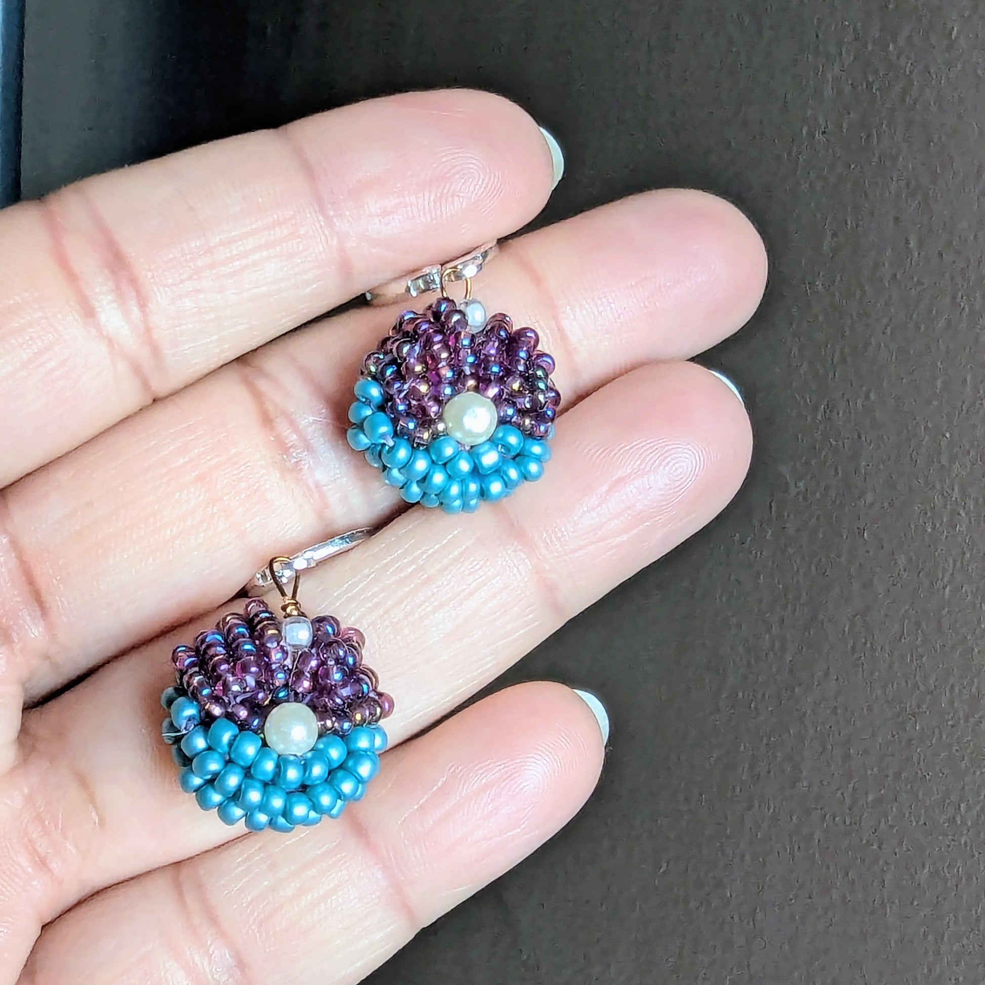 Lightweight purple and turquoise earrings symbolising balance and grace, part of the Masi Everyday Edit.