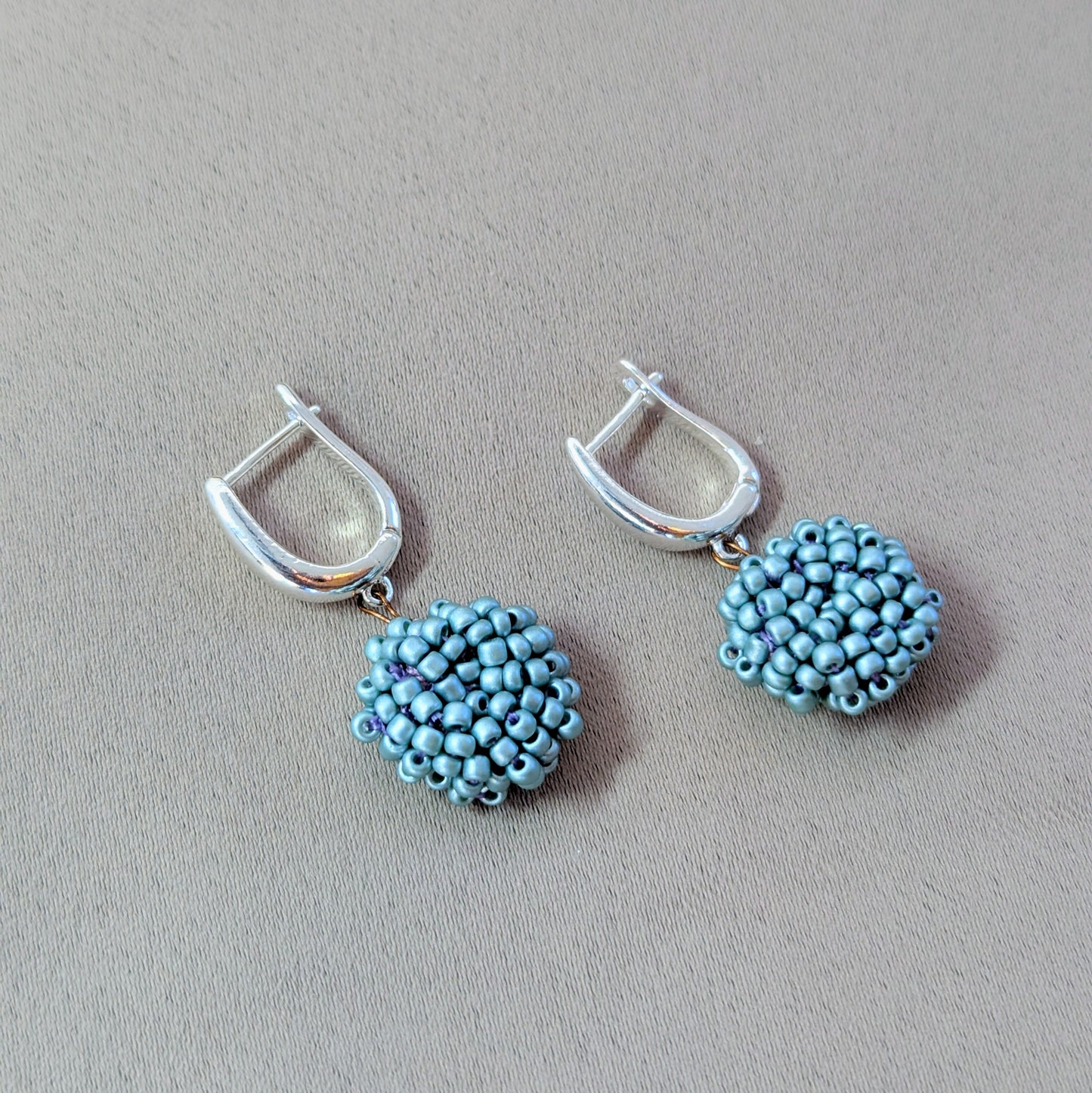 Masi Nila earrings photographed in natural light, capturing their subtle sheen and artisanal finish.