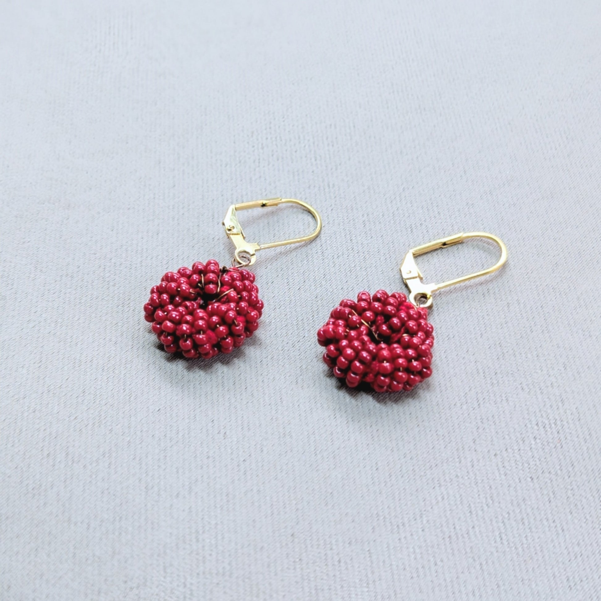 Close up view of rich red Masi everyday earrings.