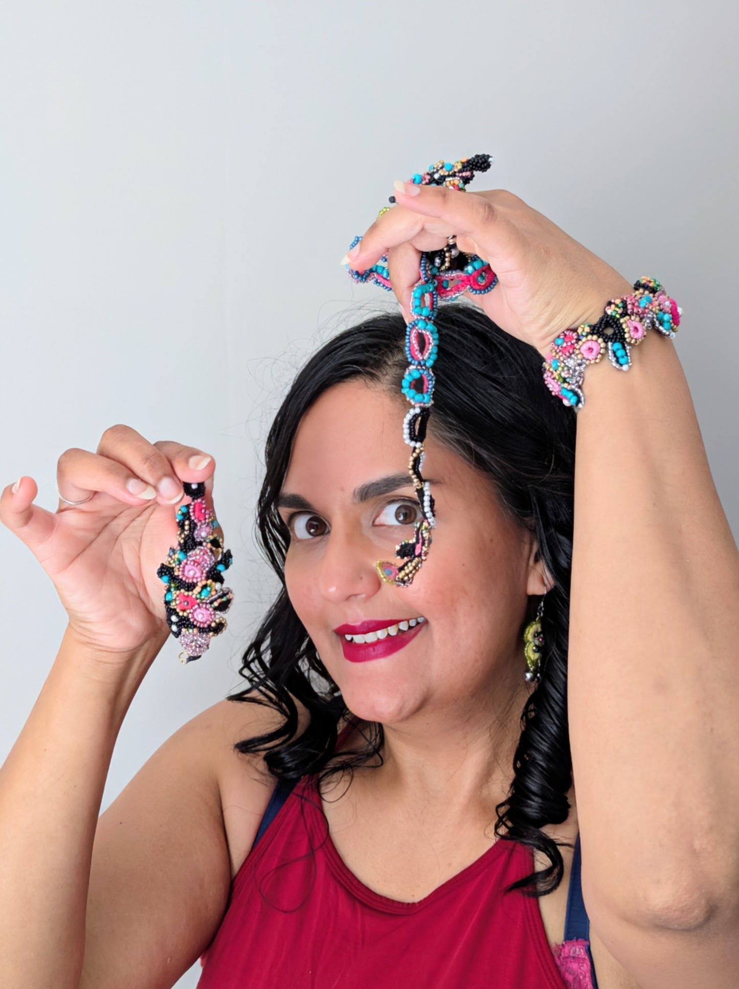 Model wearing the statement ring and bracelet elements of the Madhuri 5-in-1 Indian hand bracelet whilst holding up the detachable centrepiece and custom chain. Designed and handcrafted exclusively at Mayaani Jewellery UK for luxury jewellery inspired by heritage with sustainability and versatility.