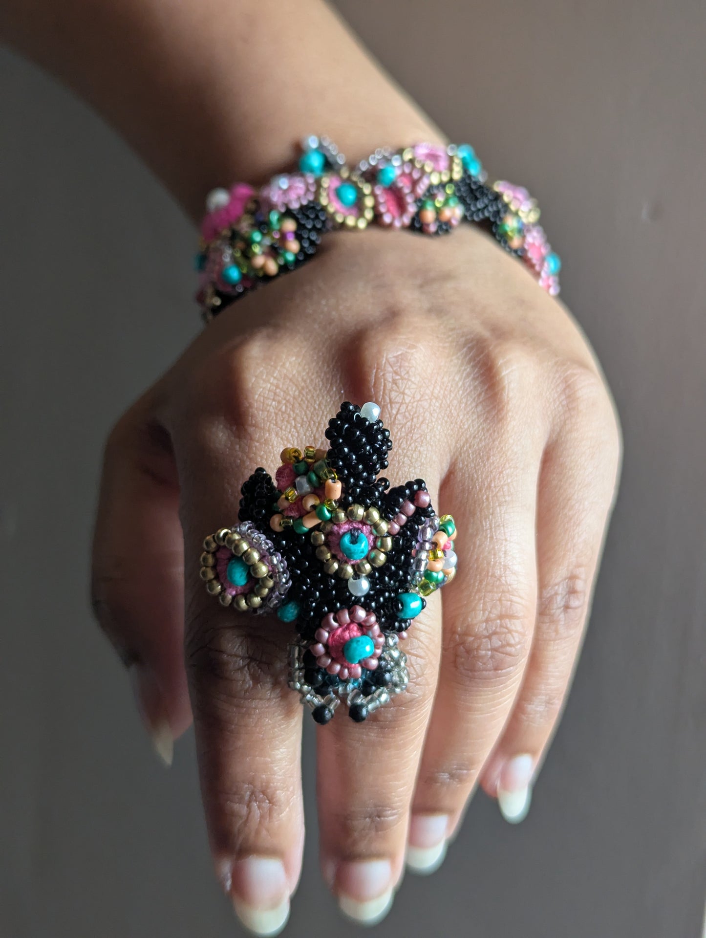 Intricately beaded Madhuri 5-in-1 Indian hand bracelet featuring turquoise, pink and black bead embroidery in a signature concept by Mayaani Jewellery UK. Pictured are the ring and separate bracelet elements of the hand bracelet.