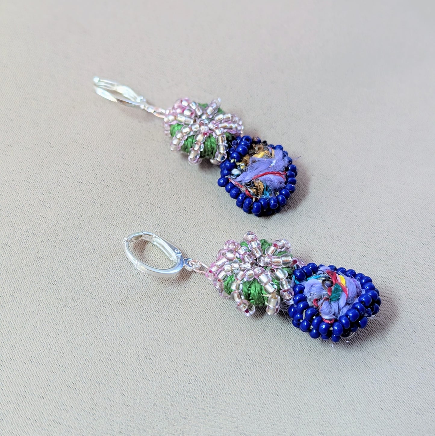 Side angle of Gaia earrings showing layered textures and antique bronze wire detailing.