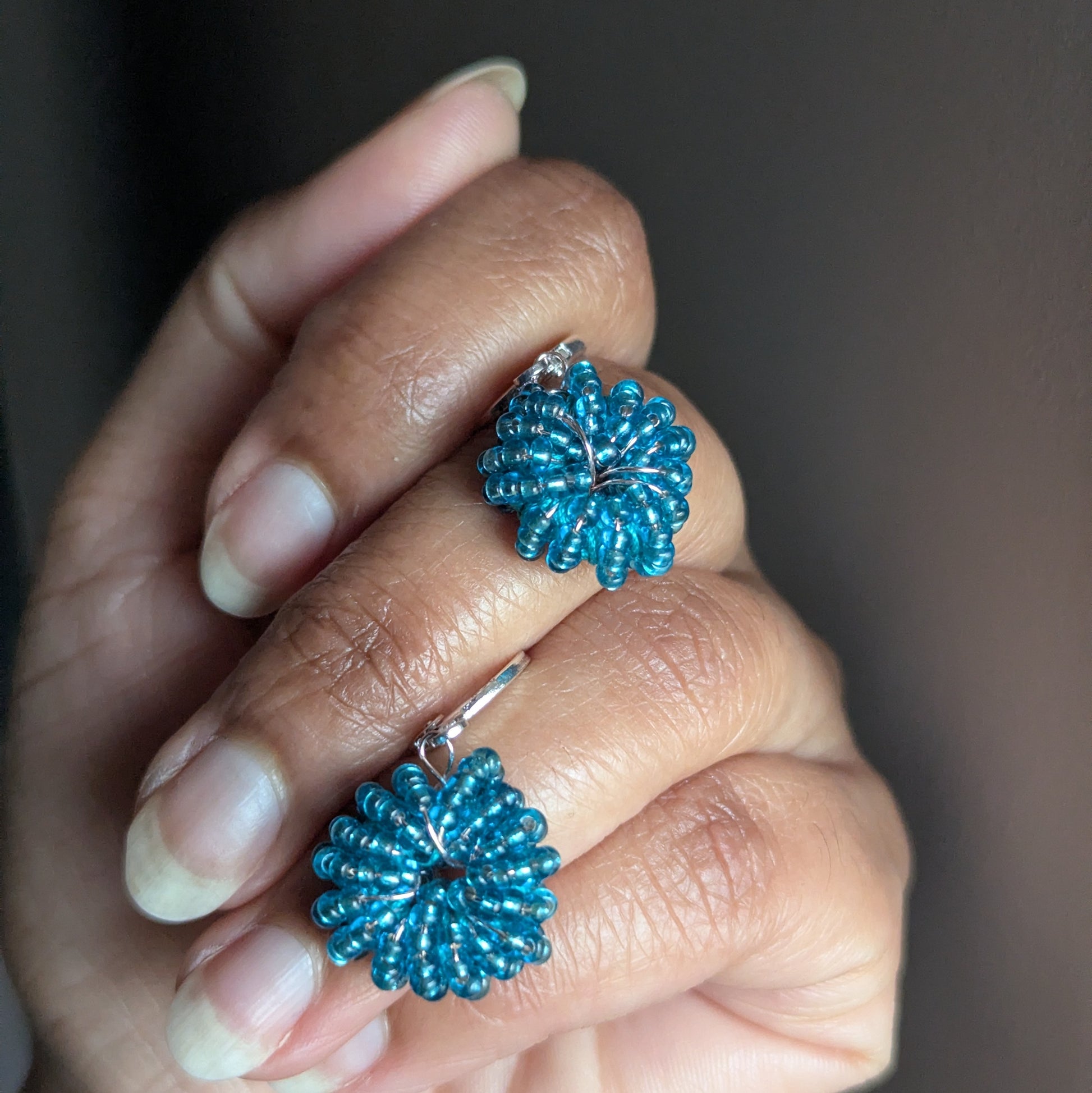 Handwoven blue seed bead earrings with sterling silver hooks and rose gold-plated copper wire, handmade in the UK.