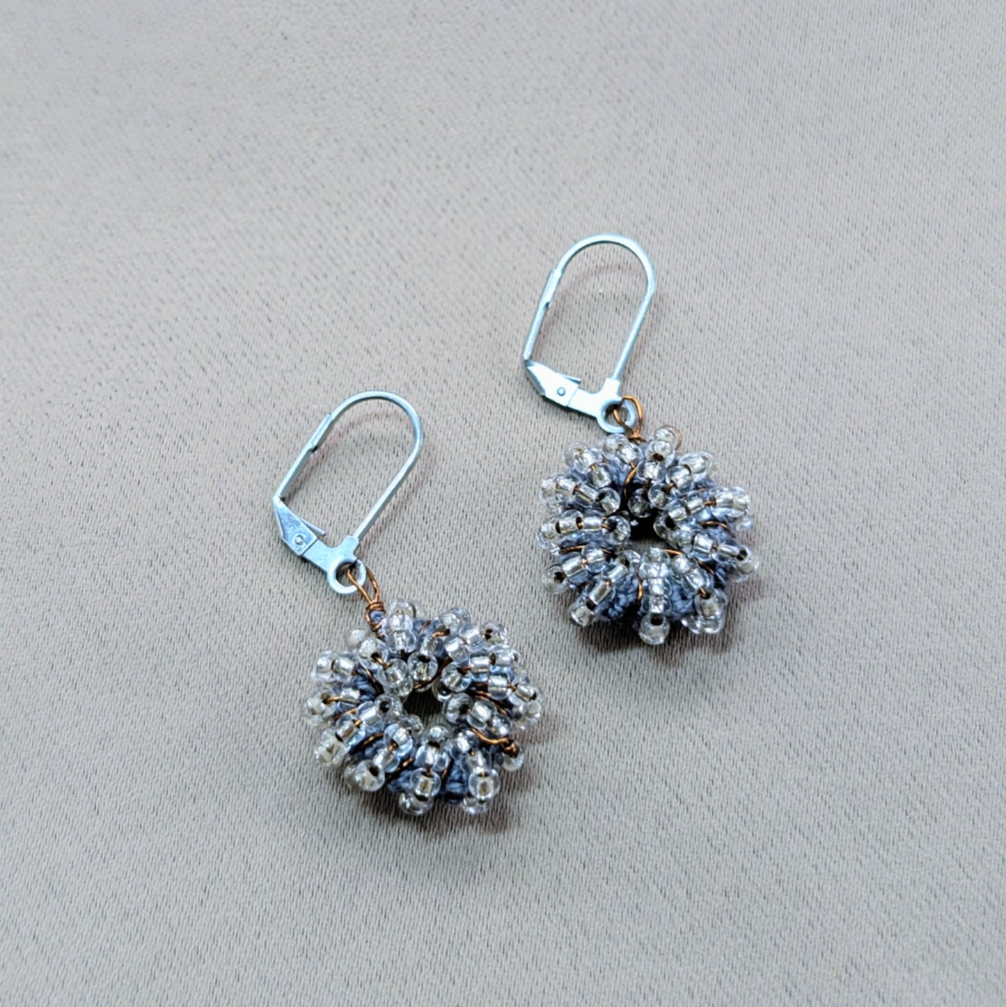 Minimalist beaded earrings handcrafted in the UK with stainless-steel clasps.