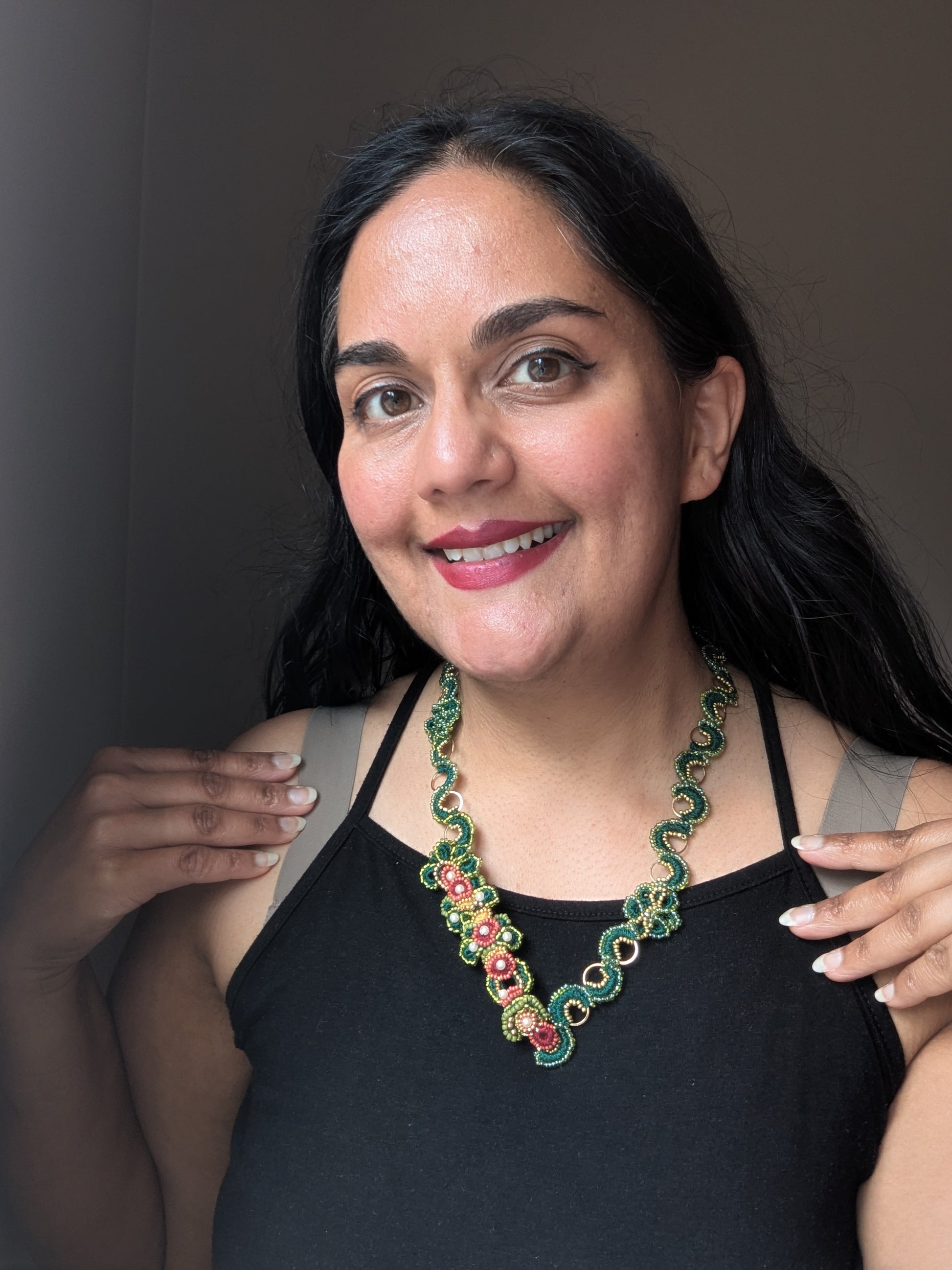 Rukmini handmade emerald green and gold custom order Mayaani Jewellery UK chain paired with the central element of the Rukmini 5-in-1 Indian hand bracelet and showcased on Mayaani founder Megha.
