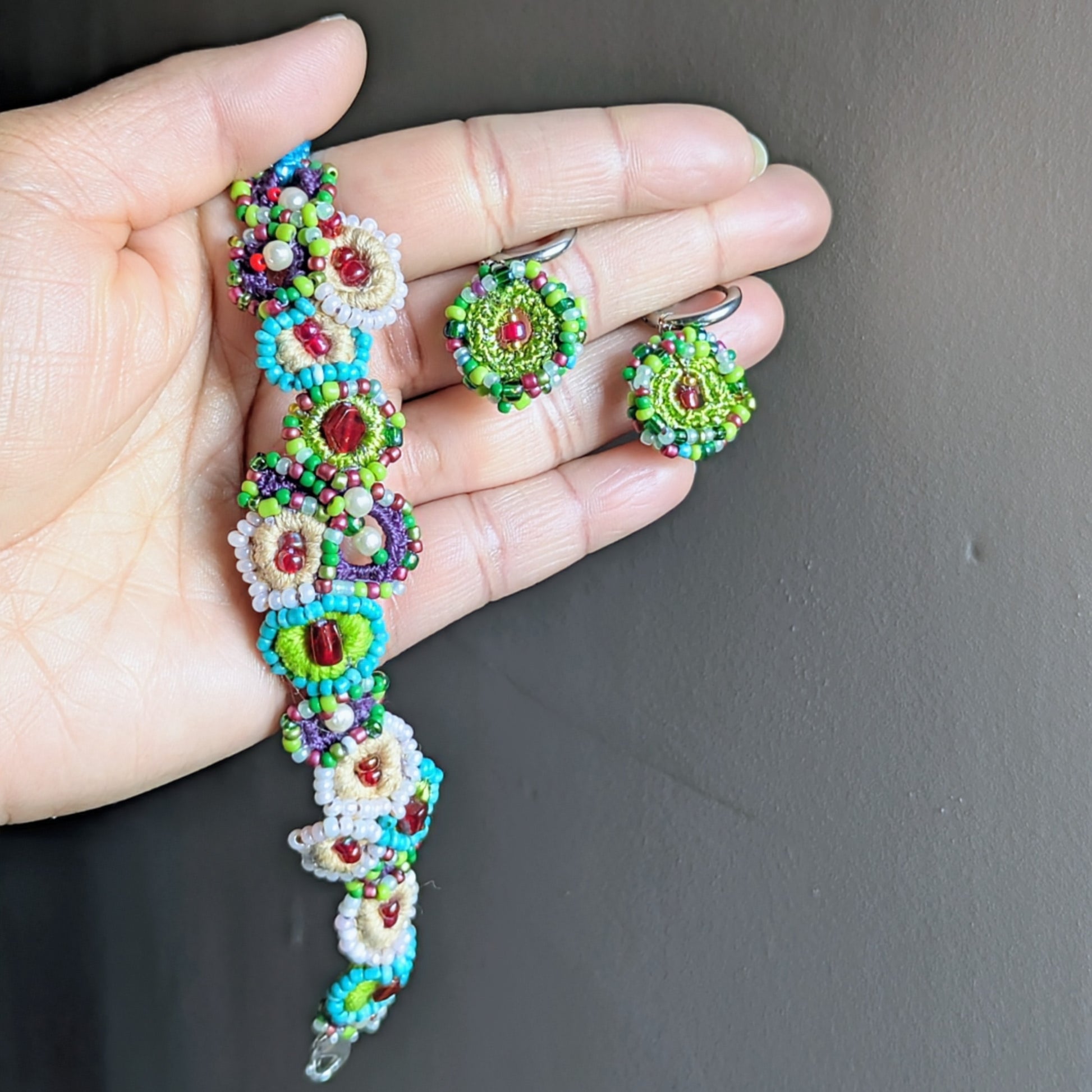 Vana Journey garden-inspired bracelet on wrist, handcrafted with Czech glass beads, vintage beads and Egyptian cotton, made in the UK.