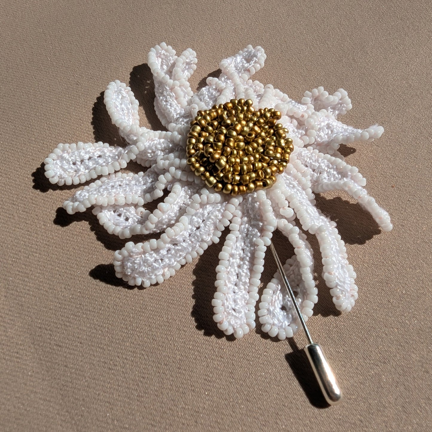 A one of a kind designer handmade daisy flower botanical brooch pin sustainably created for UK alternative luxury jewellery brand Mayaani.