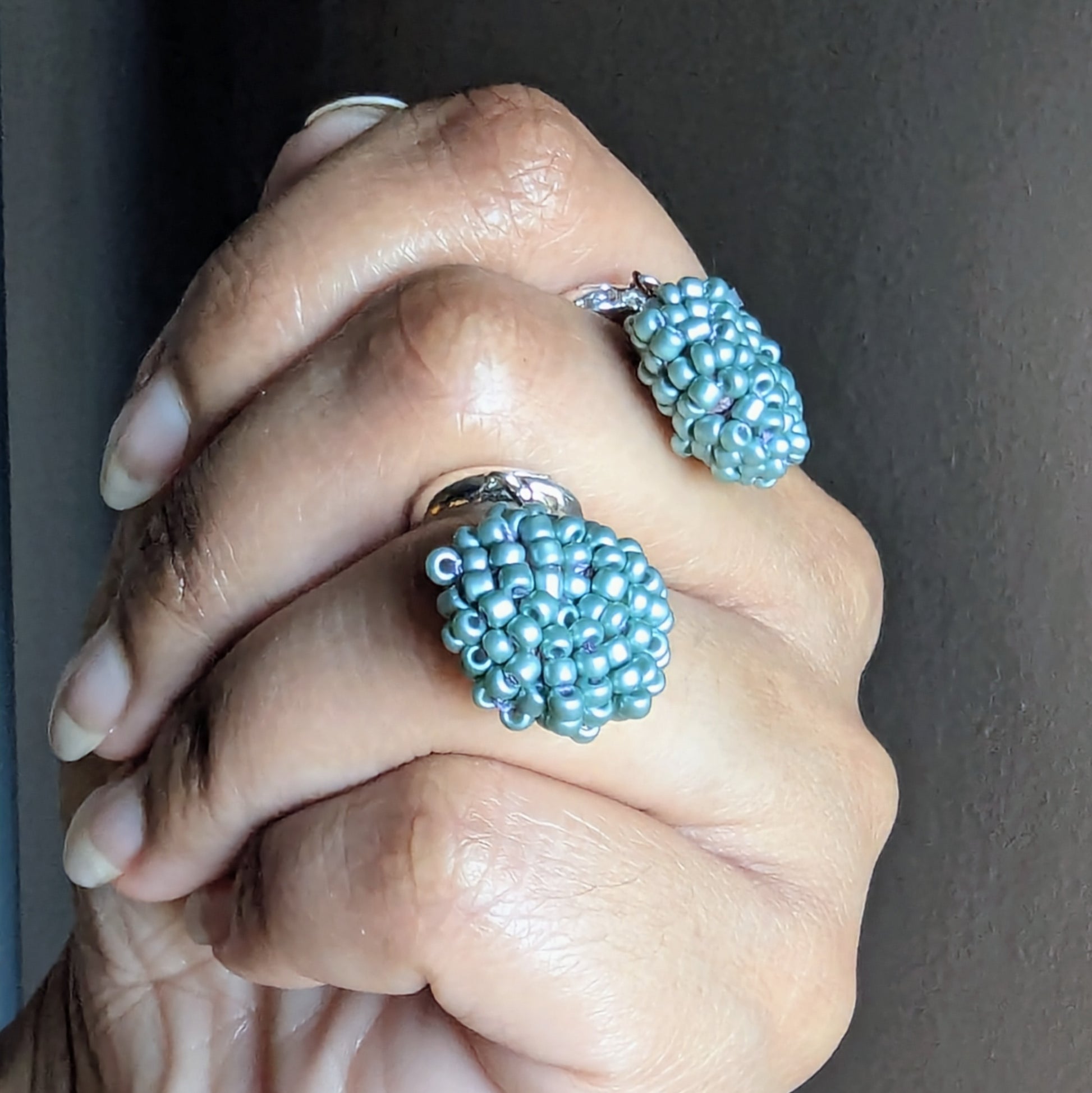 Side view of blue beaded earrings revealing fine crochet and wire wrapping craftsmanship.