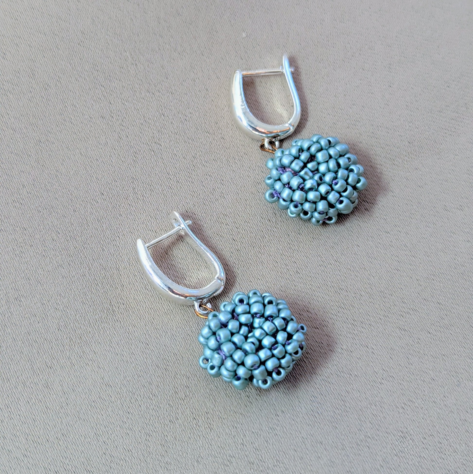Pair of Masi Nila blue bead earrings photographed up close showing premium materials and handmade artistry.
