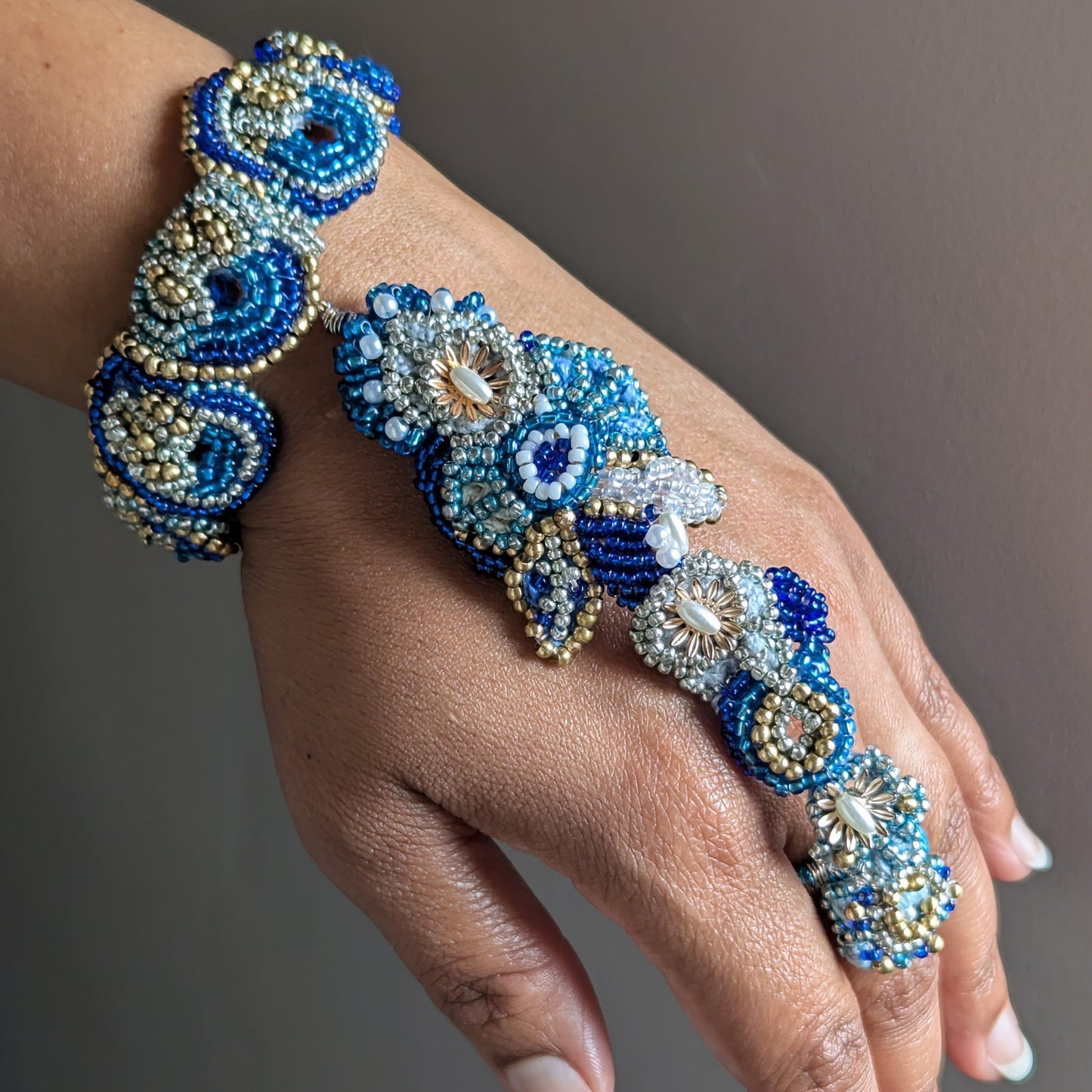 Hand modelling the Nira 5-in-1 statement blue and gold Indian hand bracelet exclusive to Mayaani Jewellery UK.