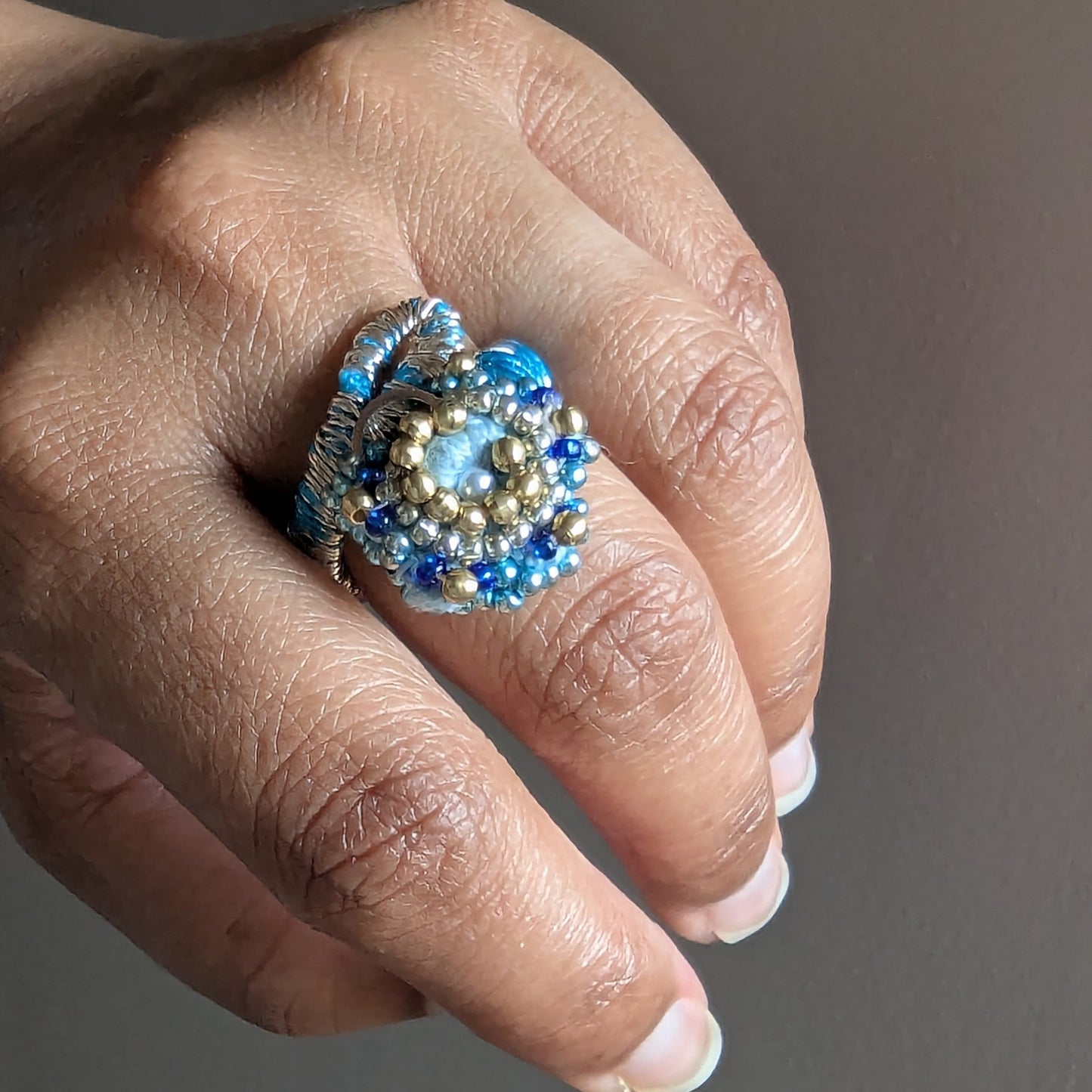 Nira cocktail ring element worn on middle finger - blue, gold and rose gold beaded ring from the Mayaani 5-in-1 hand bracelet.
