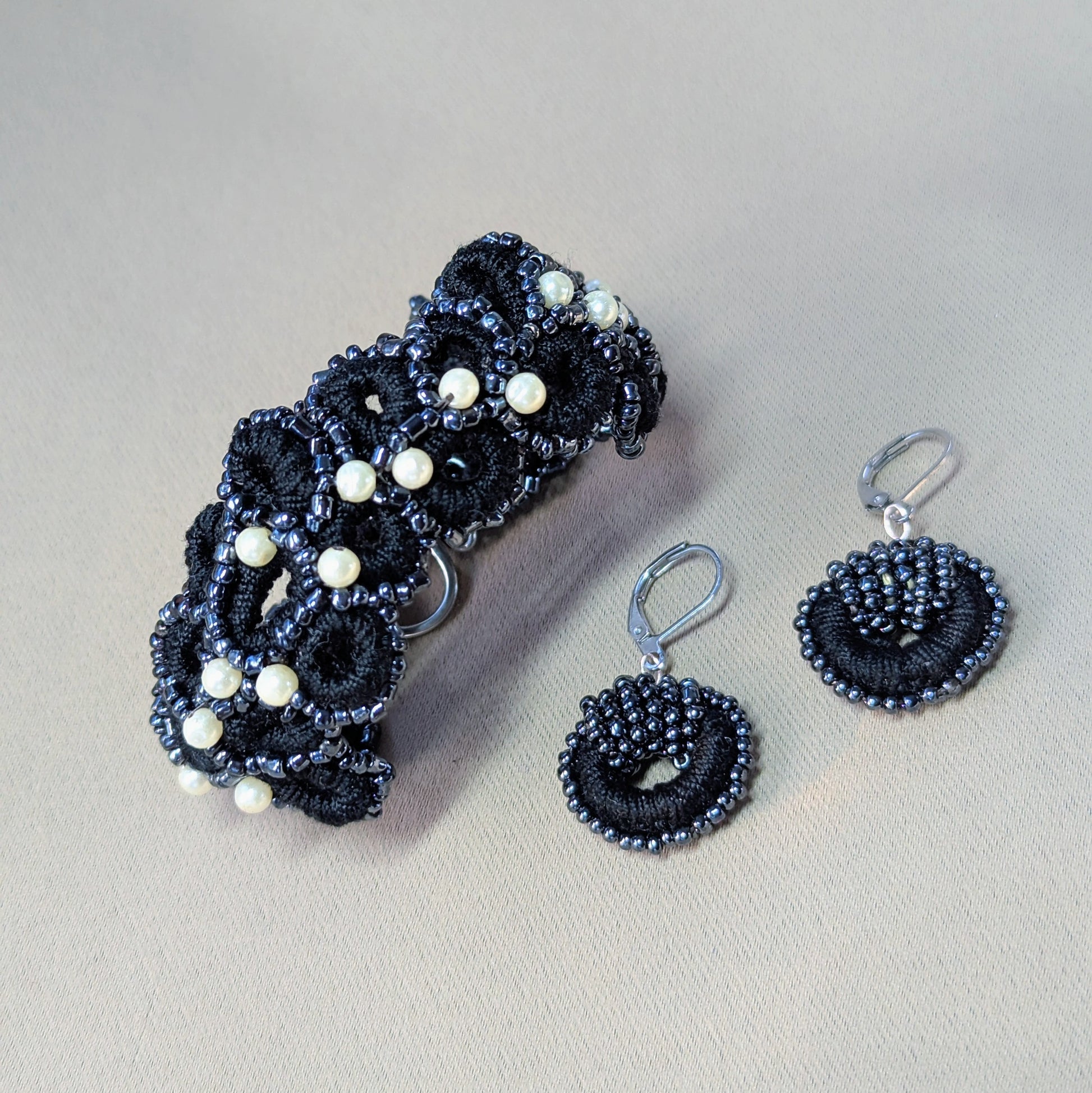 Handcrafted black crochet bracelet and matching beaded earrings set with vintage pearls from Mayaani Jewellery.