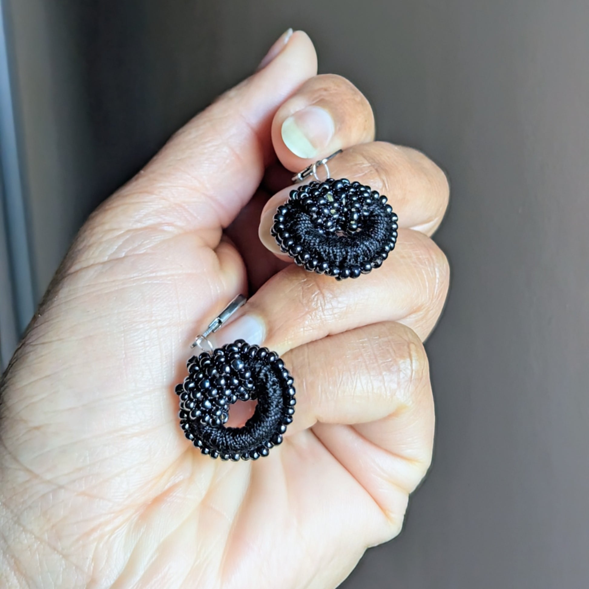 Small round black beaded earrings crafted with premium cotton and hypoallergenic clasps.