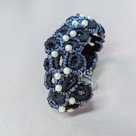 Detail view of the Nisha handmade crochet bracelet with pearl accents on a clean backdrop.