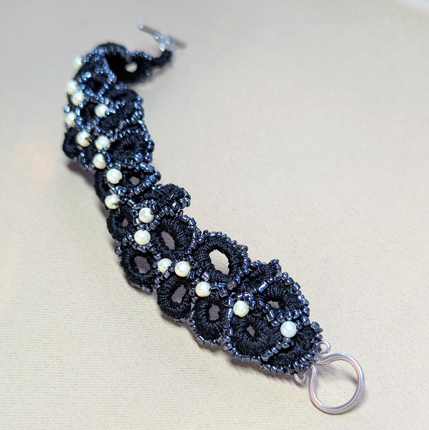 Side view of Nisha bracelet showing sculptural crochet texture and delicate vintage seed pearl detailing.