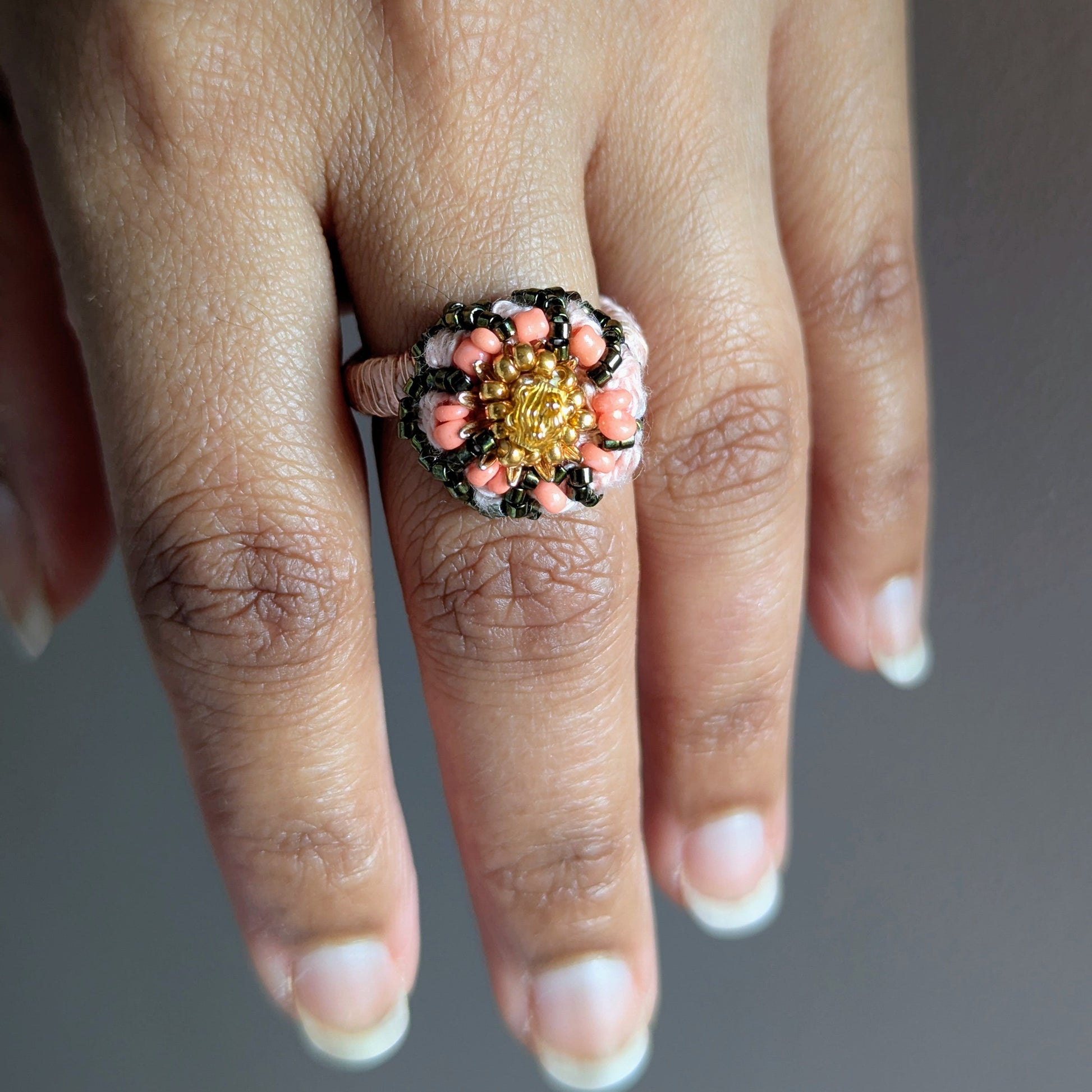Close up of the Padmika 5-in-1 separate couture cocktail ring element bead woven in Japanese Miyuki and peach seed beads featuring vintage gold beads.