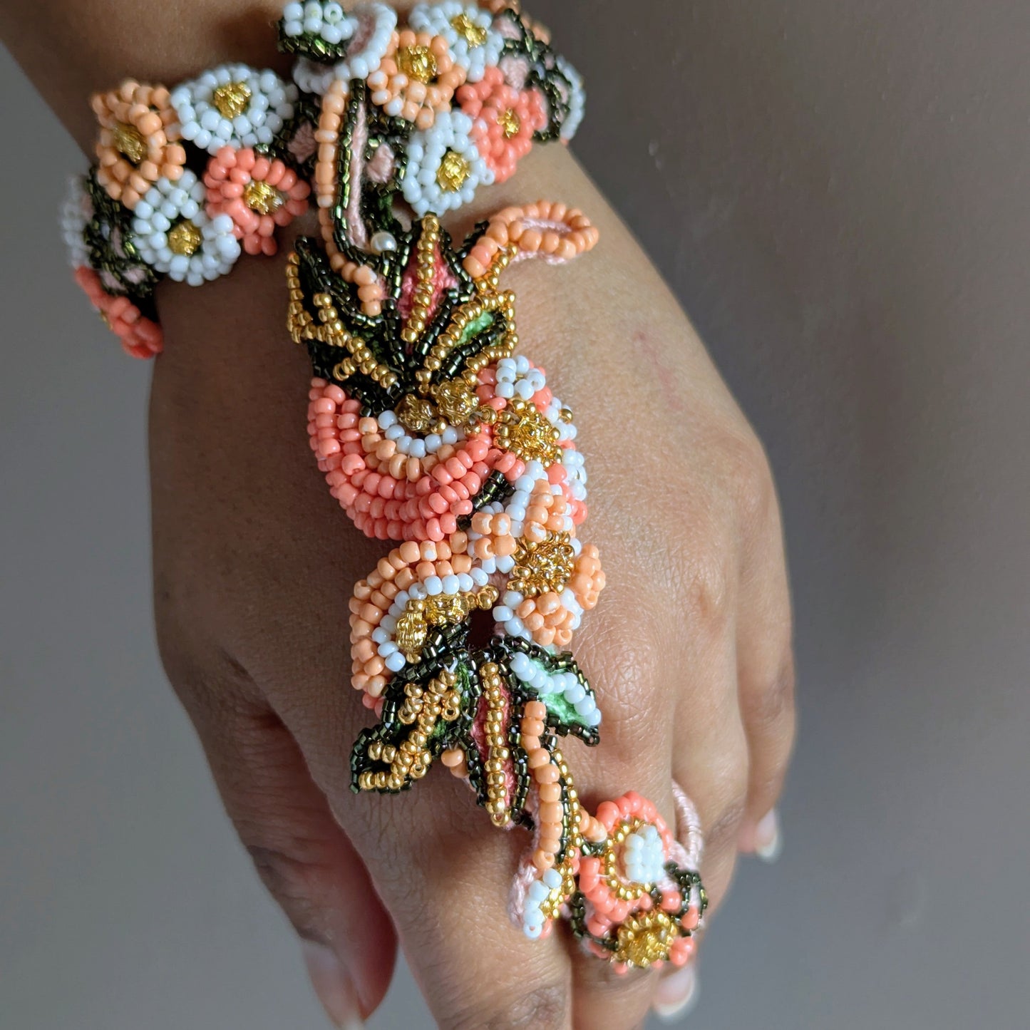 Close up view of the Padmika 5-in-1 Indian hand bracelet from above highlighting the artistic landscape of botanical elements woven throughout the piece.