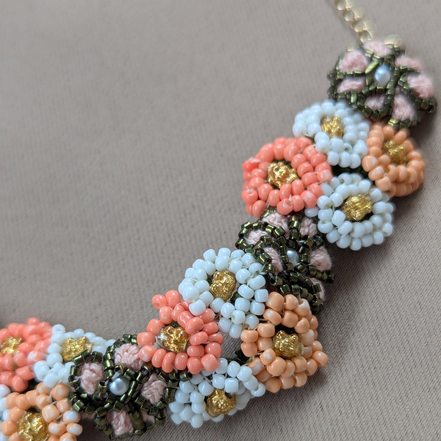 Close up view of the floral motifs within the Padmika 5-in-1 Indian haath phool separate Western style wrist bracelet element. Fusion couture jewellery made in the UK.