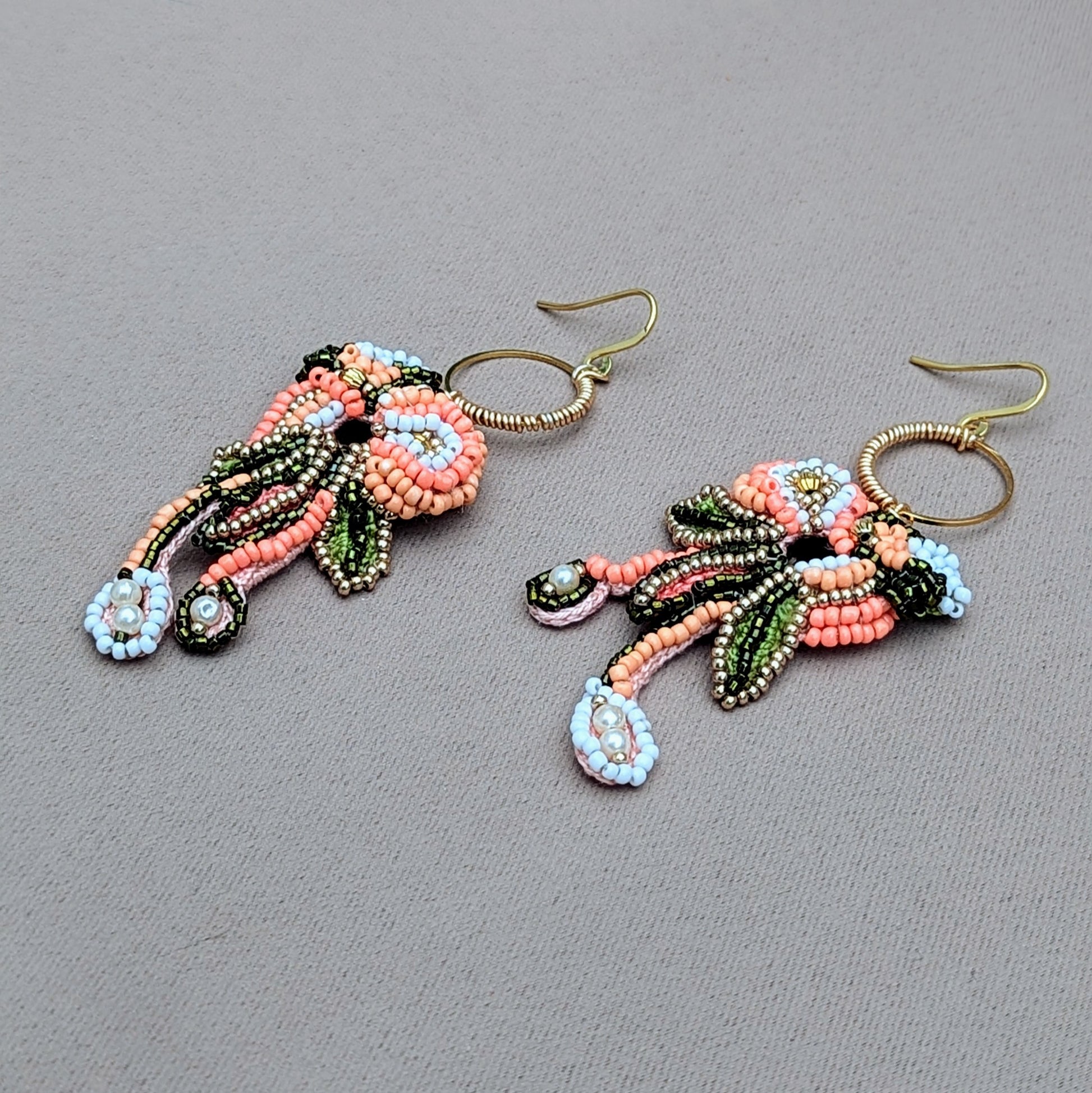 Padmika peach green and gold Indian earrings inspired by heritage colours, handcrafted statement jewellery suitable for weddings and celebrations.