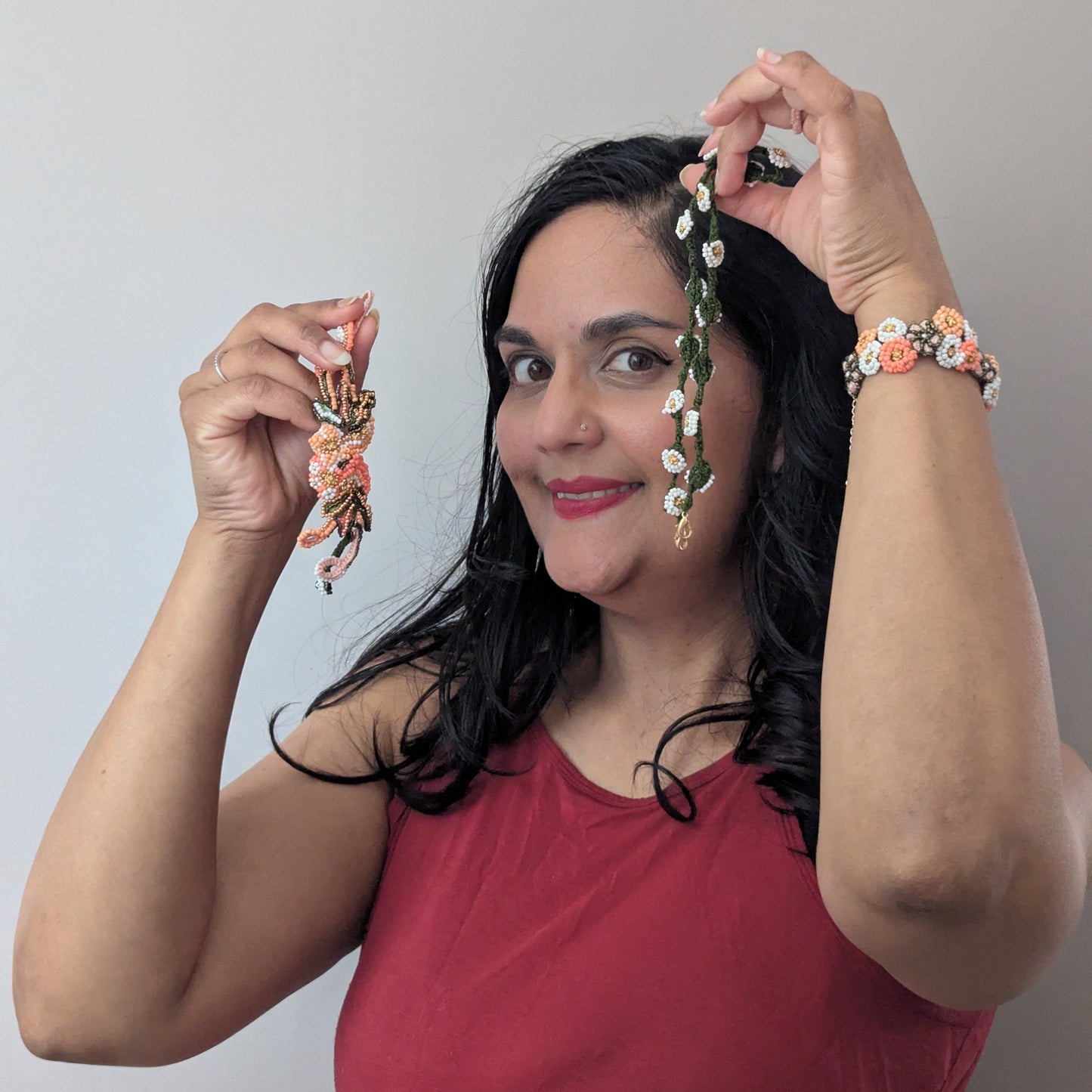 Megha of Mayaani UK wearing the Padmika statement Western style wrist bracelet whilst holding up the central haath phool section and Padmika custom chain.