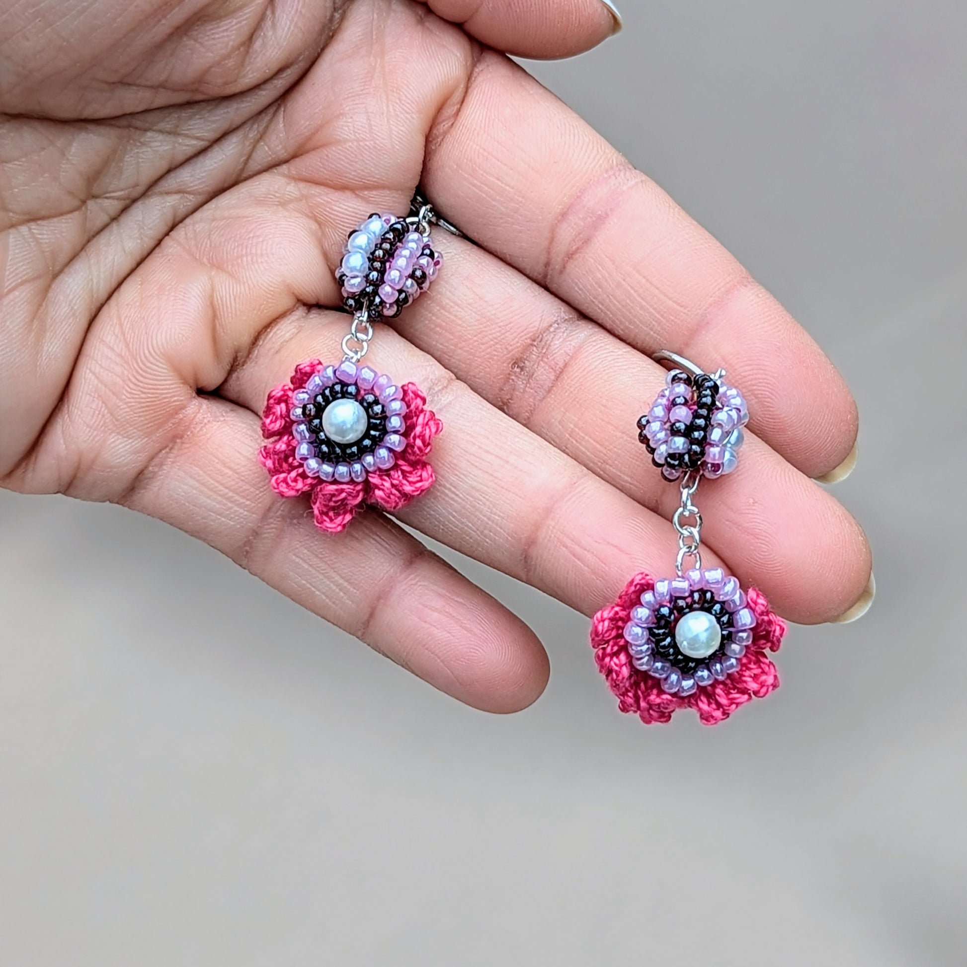 Detailed view of purple, pink and white Indian scrap bead earrings with eco-conscious craftsmanship.