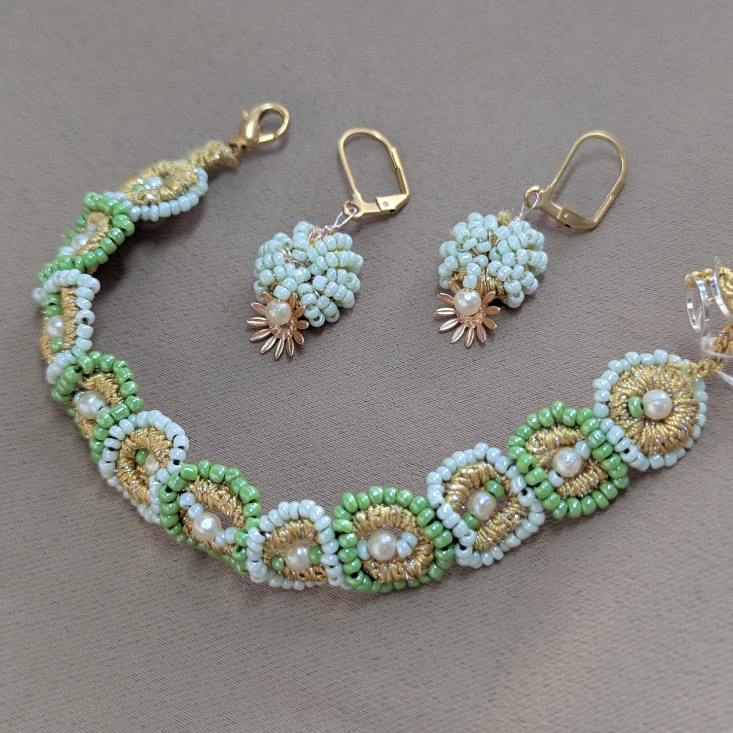 Fine beaded jewellery set in mint green, gold and pearl featuring intricate detailing unique to sustainable UK jewellery brand Mayaani.