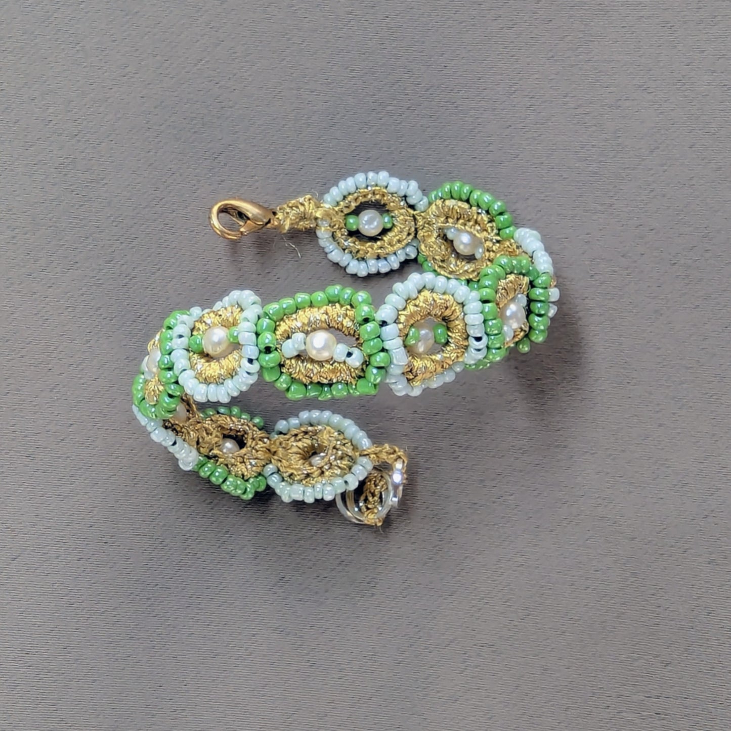 Hand woven fine beaded mint green, gold and seed pearl bracelet crafted using sustainable processes in the UK.