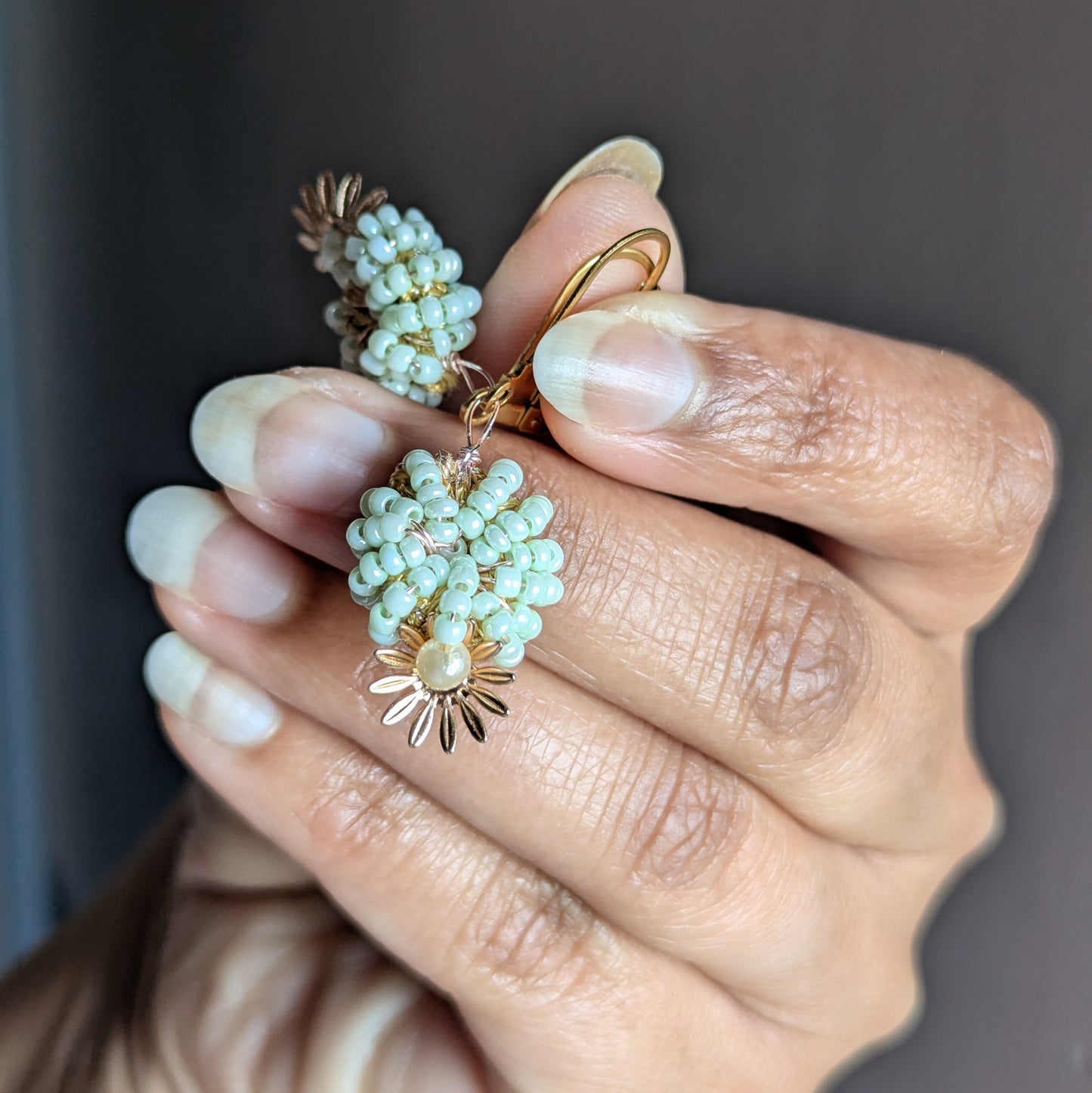 Artisan-made mint and pearl earrings featuring intricate beadwork, triple-mercerised cotton, and antique bronze wire by Mayaani Jewellery.