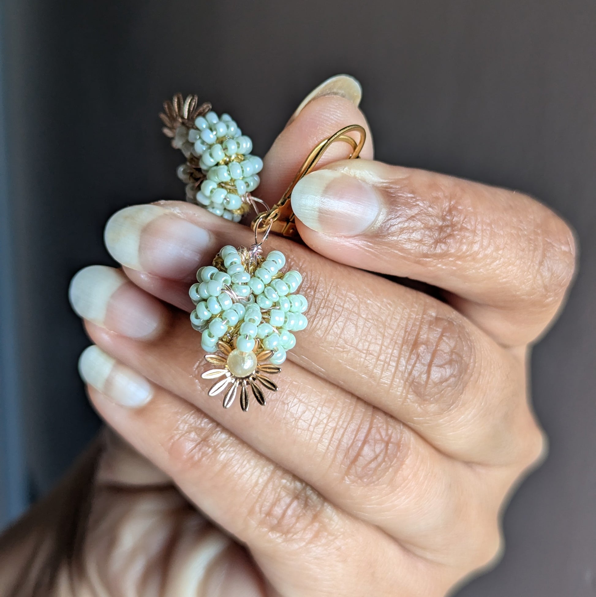 Artisan-made mint and pearl earrings featuring intricate beadwork, triple-mercerised cotton, and antique bronze wire by Mayaani Jewellery.
