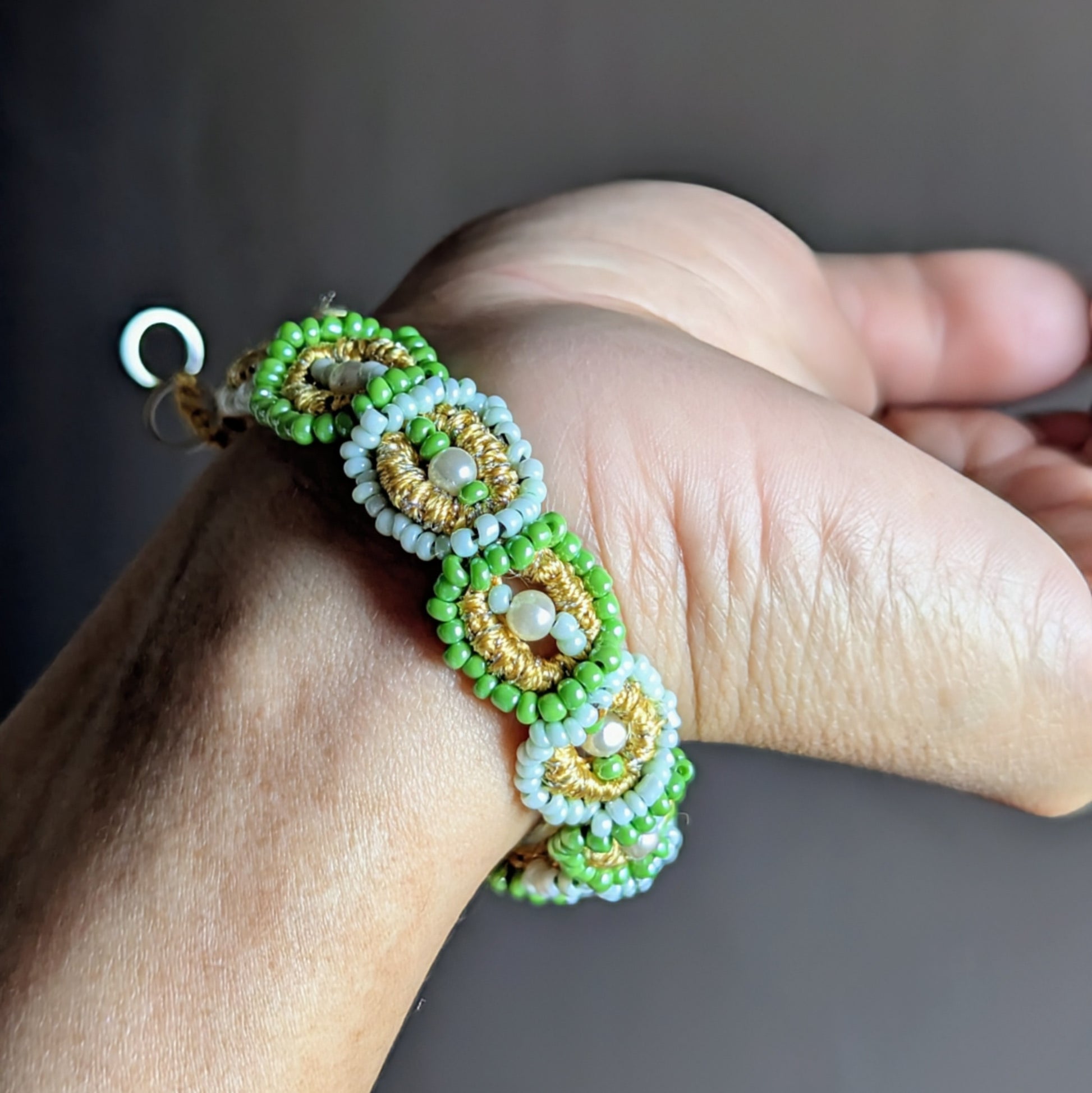 Pranaya green and pearl beaded bracelet handmade in the UK with crochet, bead embroidery, and vintage seed pearls.