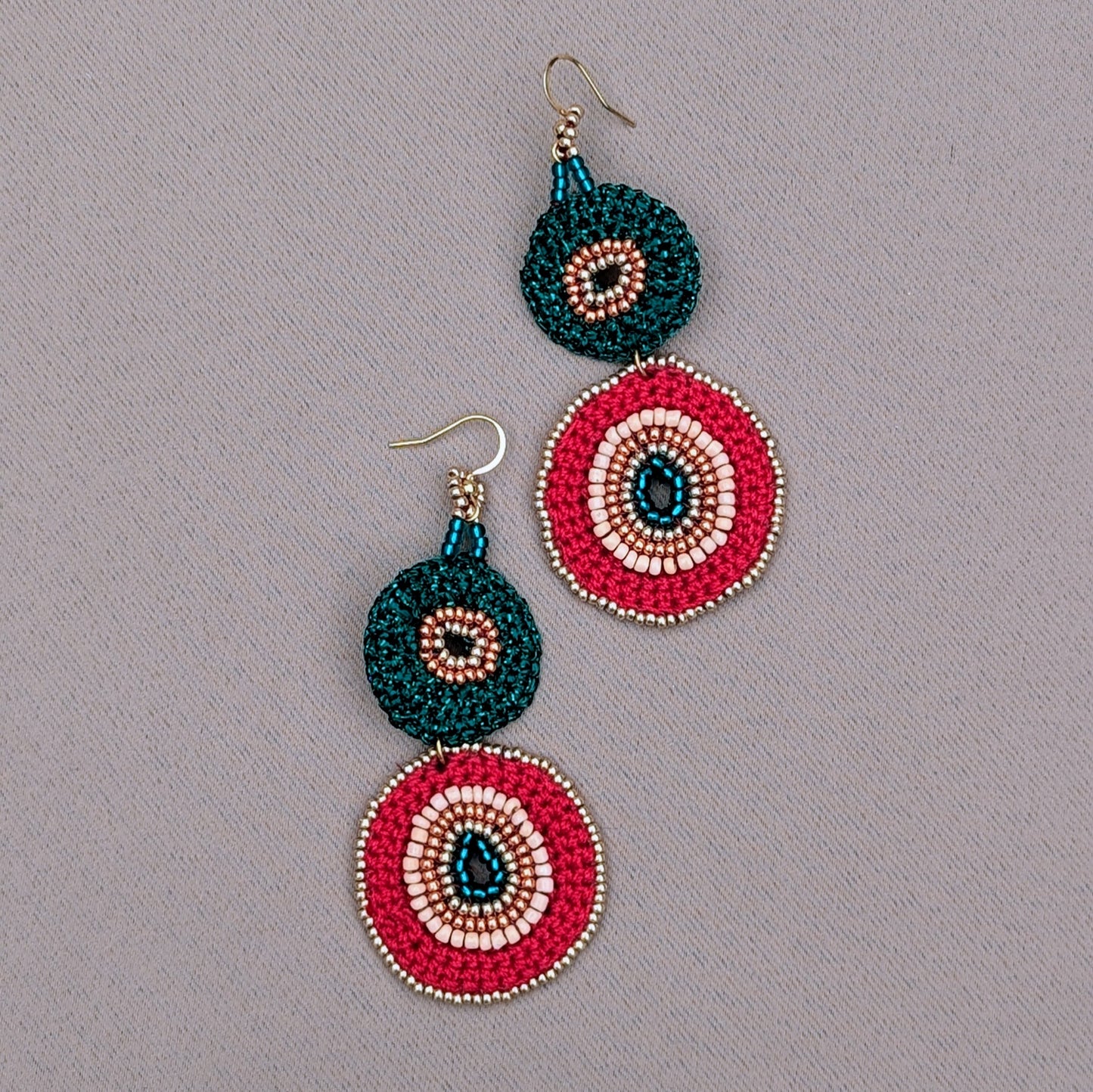 A unique artisan pair of red, green and gold Indian inspired earrings unique to Mayaani Jewellery UK. Sustainably slow made they are designed to be lightweight, celebrate heritage, individuality and sustainability.