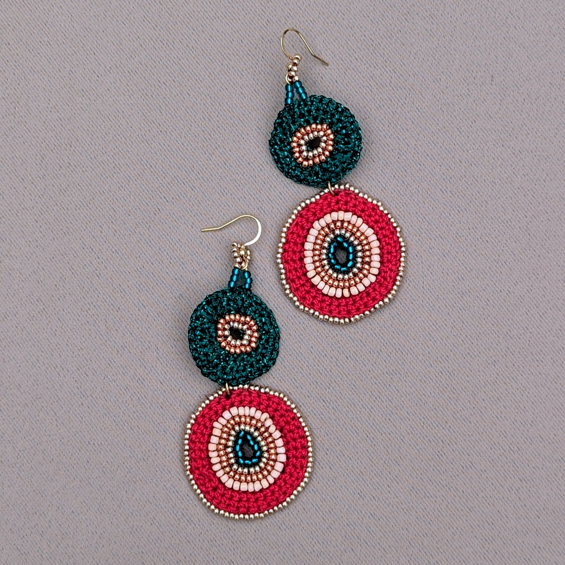 A unique artisan pair of red, green and gold Indian inspired earrings unique to Mayaani Jewellery UK. Sustainably slow made they are designed to be lightweight, celebrate heritage, individuality and sustainability.