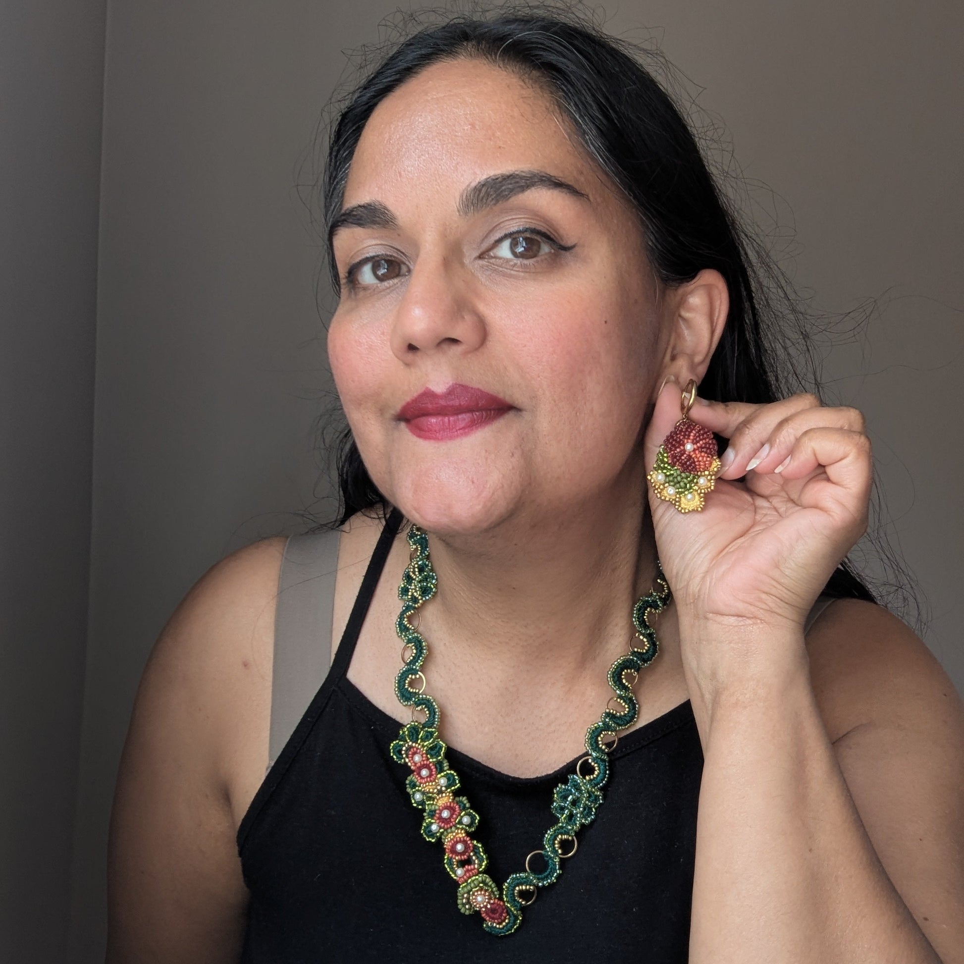 Megha founder of Mayaani Jewellery wearing Rukmini handmade drop earrings and botanical necklace - one of a kind consscious luxury Indian inspired jewellery handcrafted in the UK.