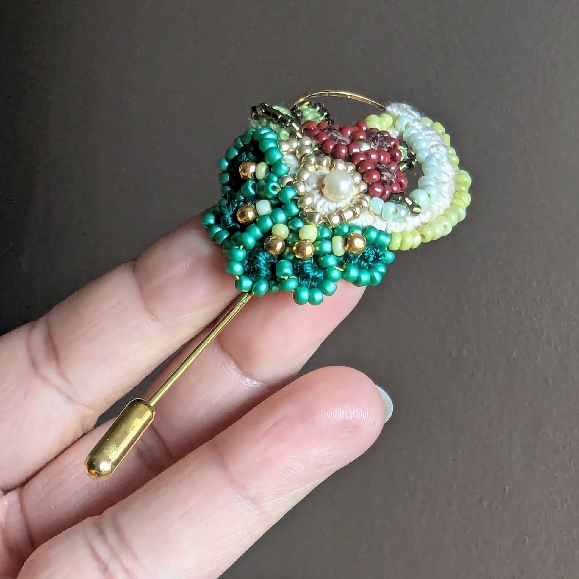 Close-up of Sarika artisan brooch showing Czech glass seed beads, vintage gold beads and pearl centre detail.