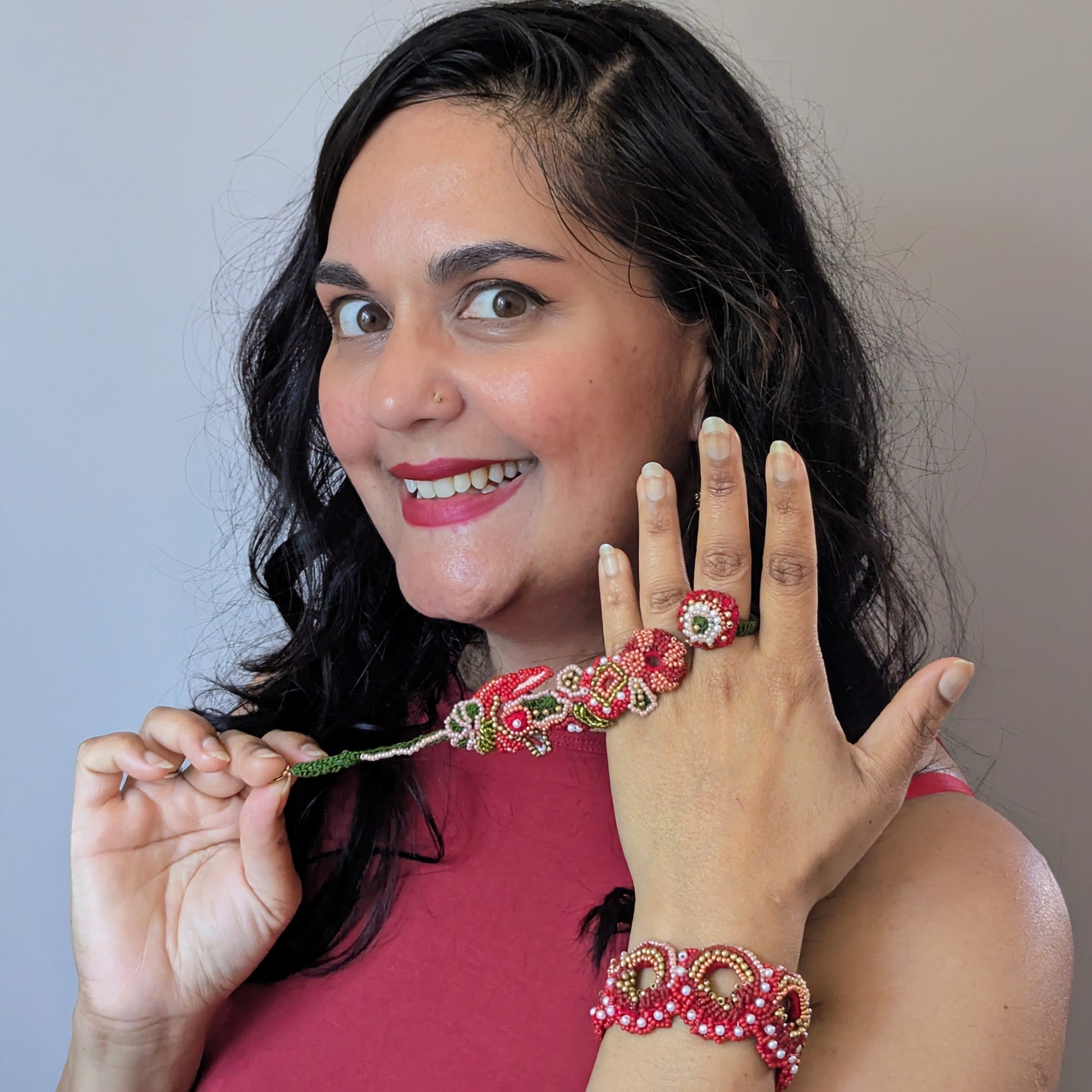 Mayaani UK designer Megha wearing the Shreya red gold 5-in-1 Indian hand bracelet showing the way the piece transforms into separate pieces.