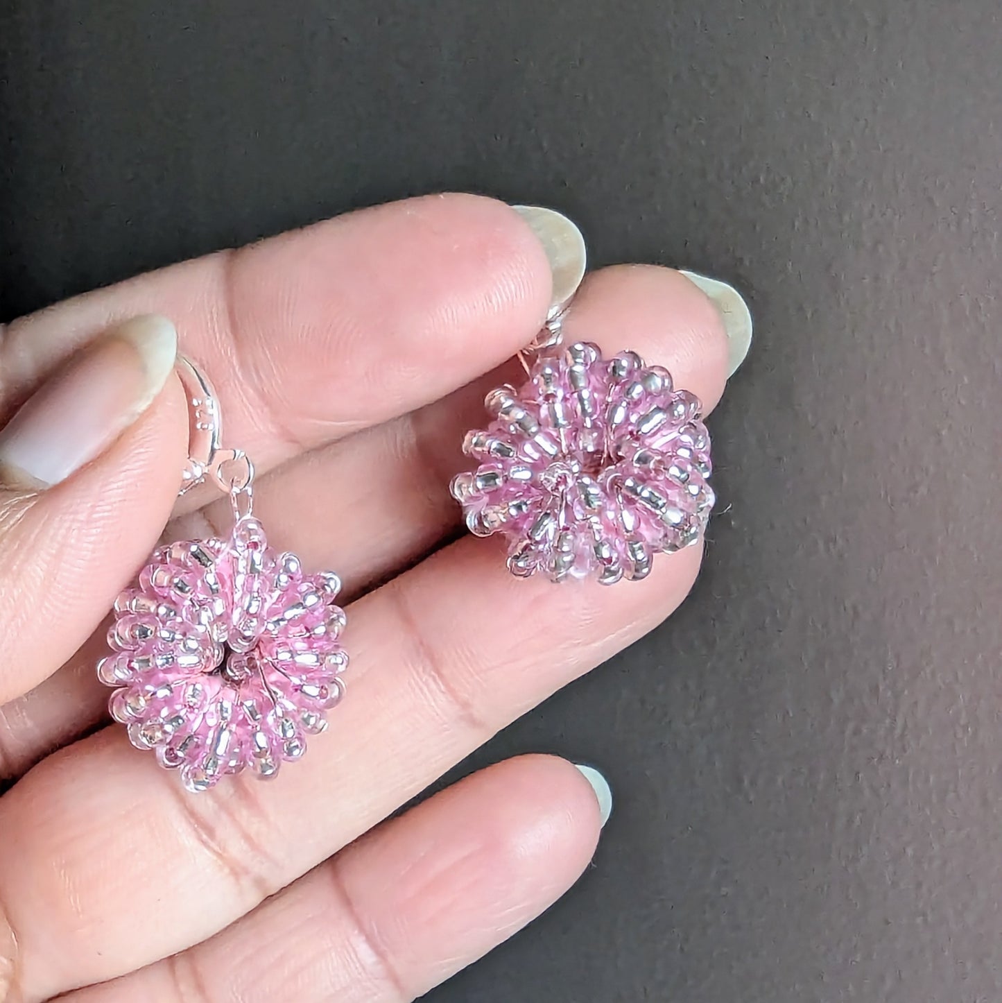 Sustainable pink beaded earrings symbolising love and renewal.