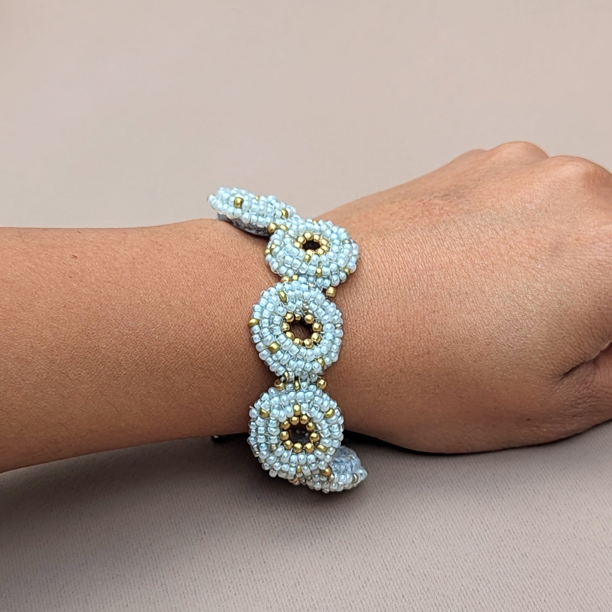 Artisanal winter-themed bracelet in silver-blue and gold tones, one of a kind by Mayaani Jewellery.