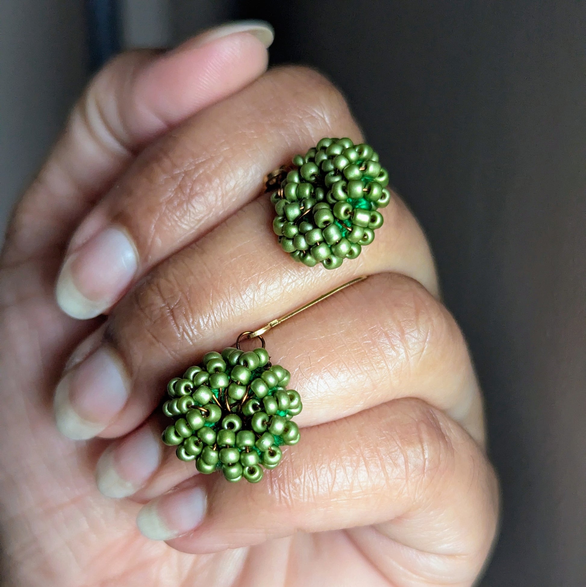 One-of-a-kind green and gold beaded earrings inspired by family and tradition.
