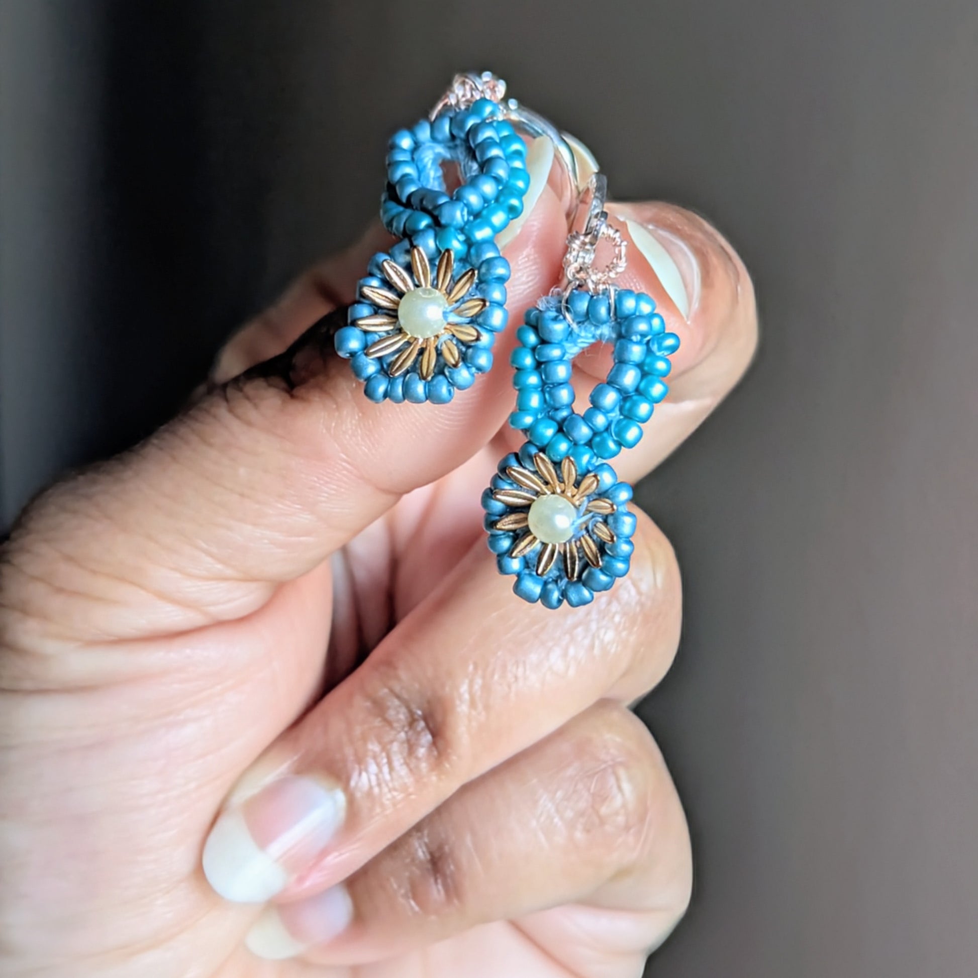 Tara earrings photographed in natural light, showing delicate craftsmanship and celestial inspiration.